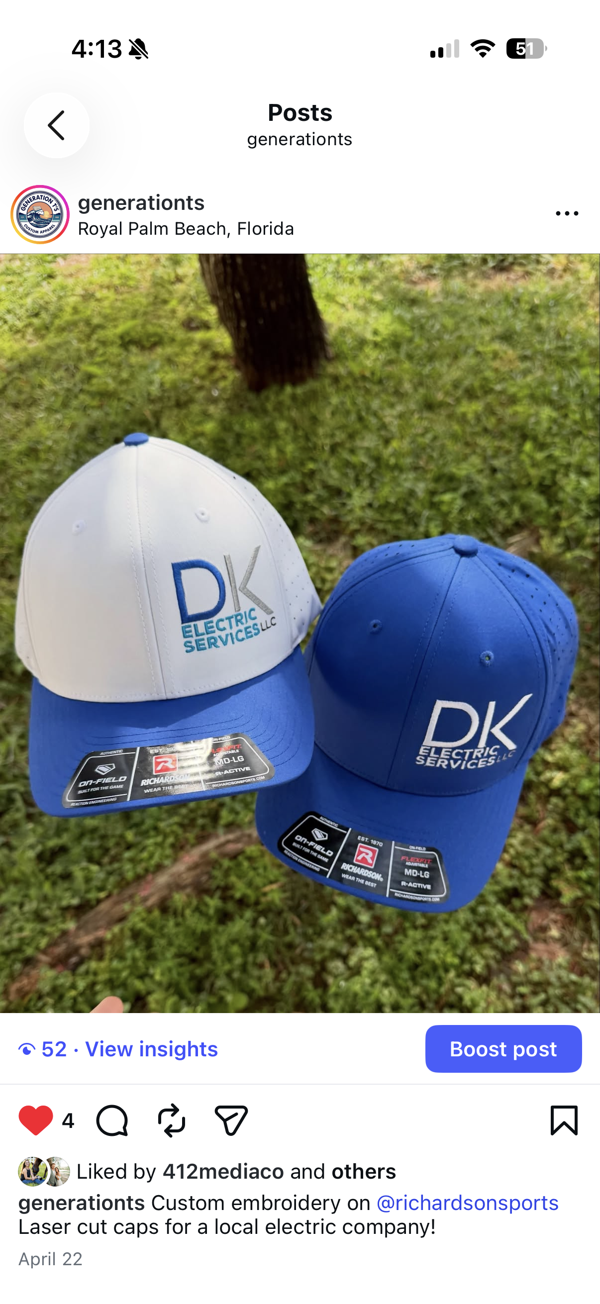 A beige and gray Richardson cap with a logo that reads 'Garage Tastic!' and a black and white sticker that says 'Richarson Original 112 Trucker Adjustable.' The cap is placed on a black surface with a zipper.