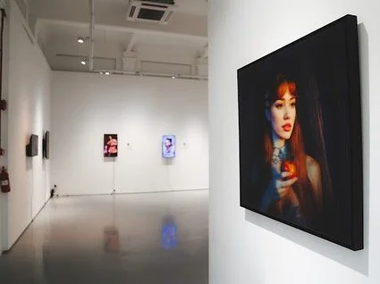 Installation view of “EVA” by Shavonne Wong at The Columns Gallery, Singapore, featuring a lenticular portrait alongside digital video works exploring identity and presence.