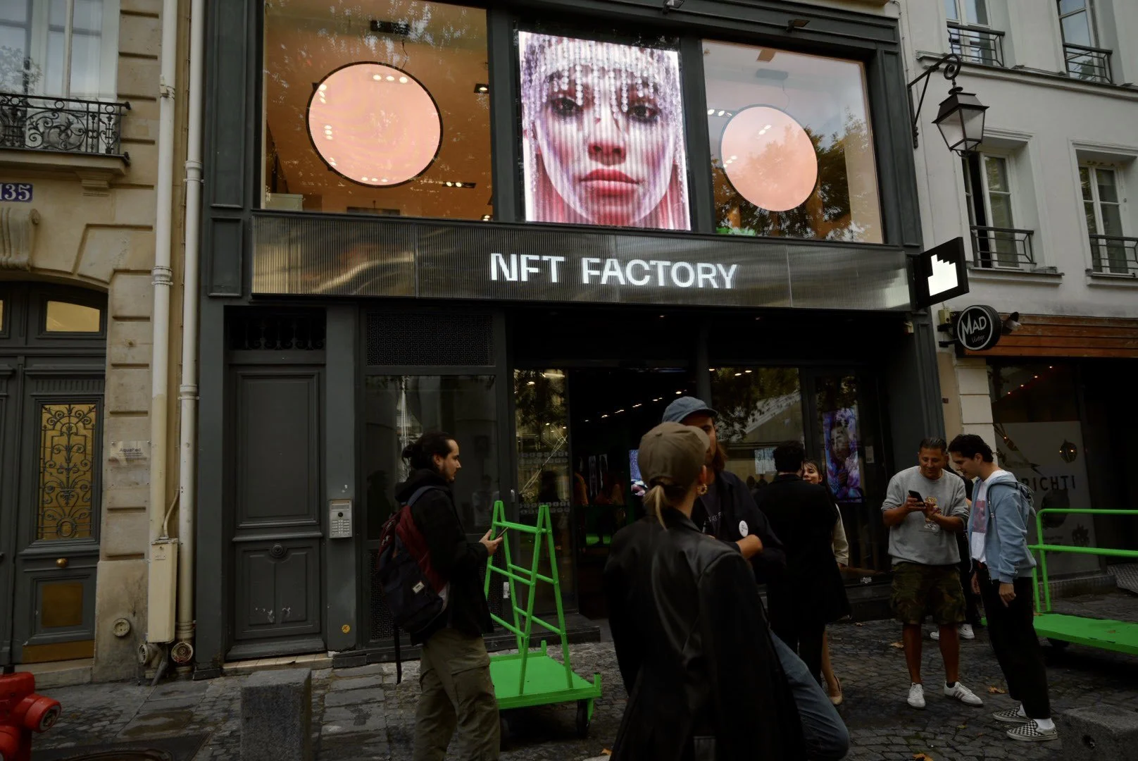Shavonne Wong’s solo show at NFT Factory Paris, featuring her digital portrait ‘Everything Yet Nothing’ displayed prominently on the building facade.