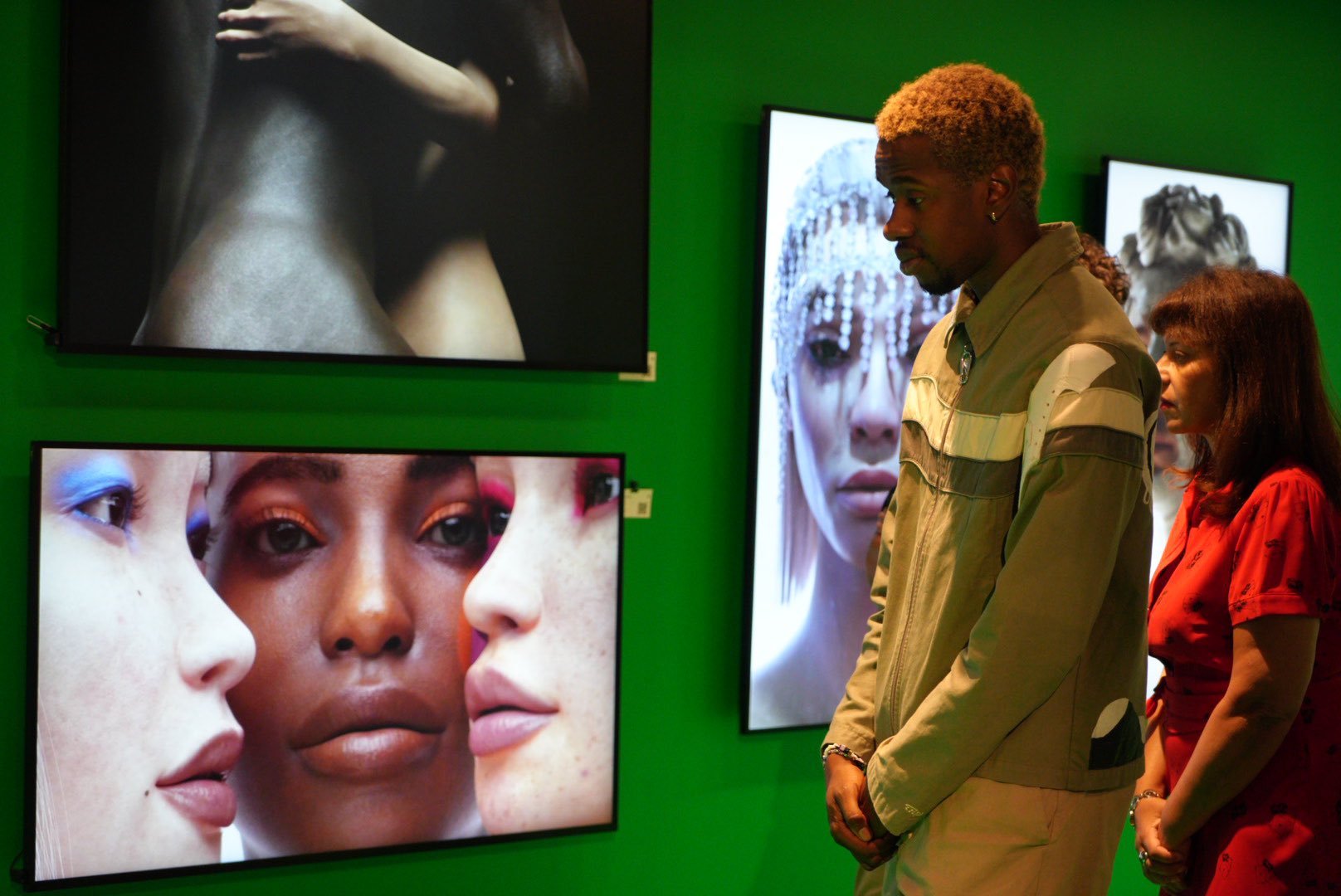 Visitors viewing Shavonne Wong’s digital portraits at her NFT Factory solo exhibition in Paris, showcasing hyperreal virtual models and identity-driven works.