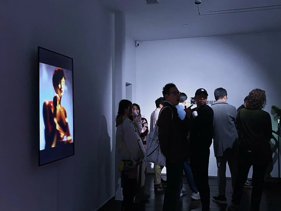 Exhibition view of Shavonne Wong's work at Ora-Ora Gallery during Digital Art Fair 2024, featuring a portrait video installation with visitors interacting in the gallery space.