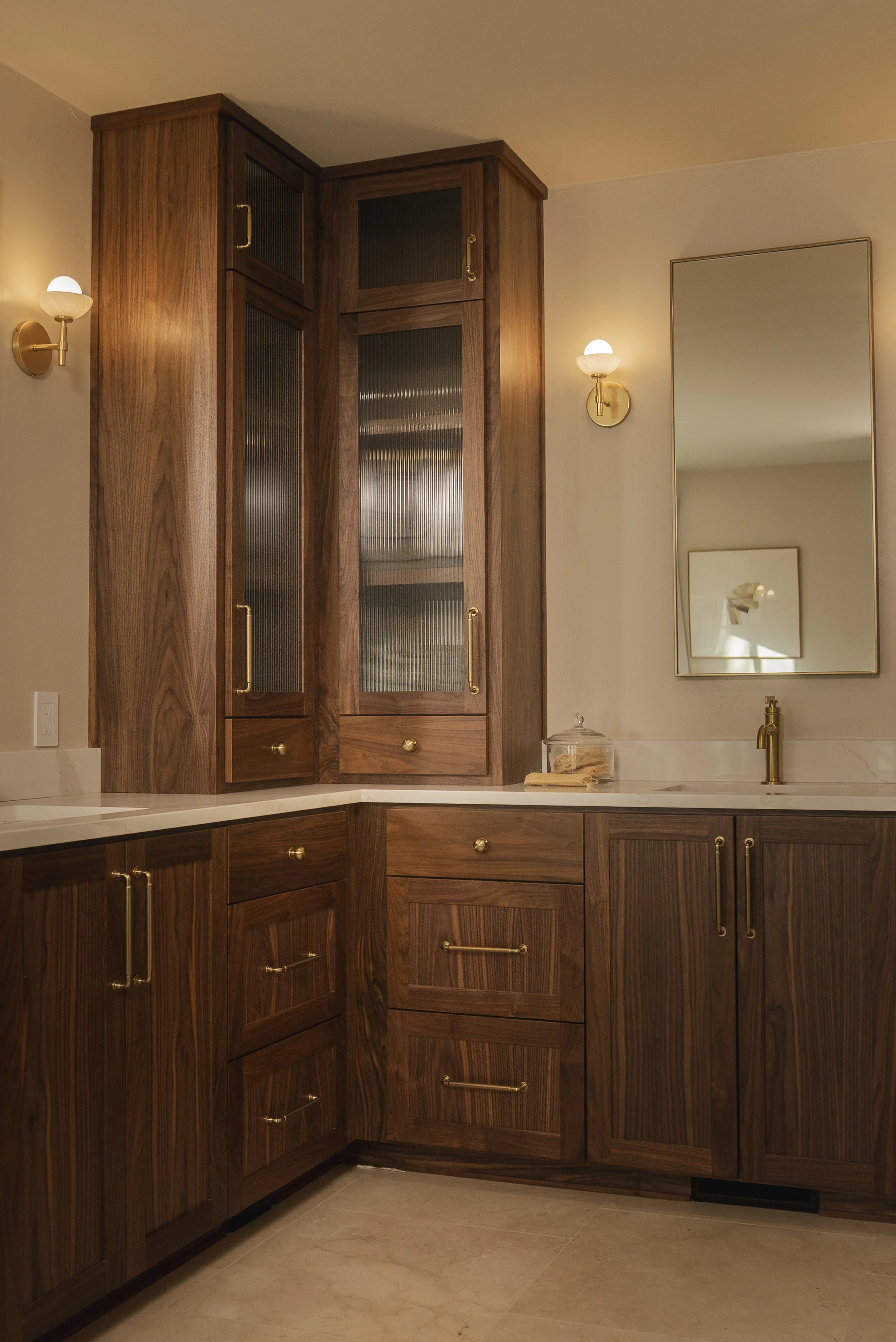 Luxury tile and plumbing fixtures in remodeled bathroom