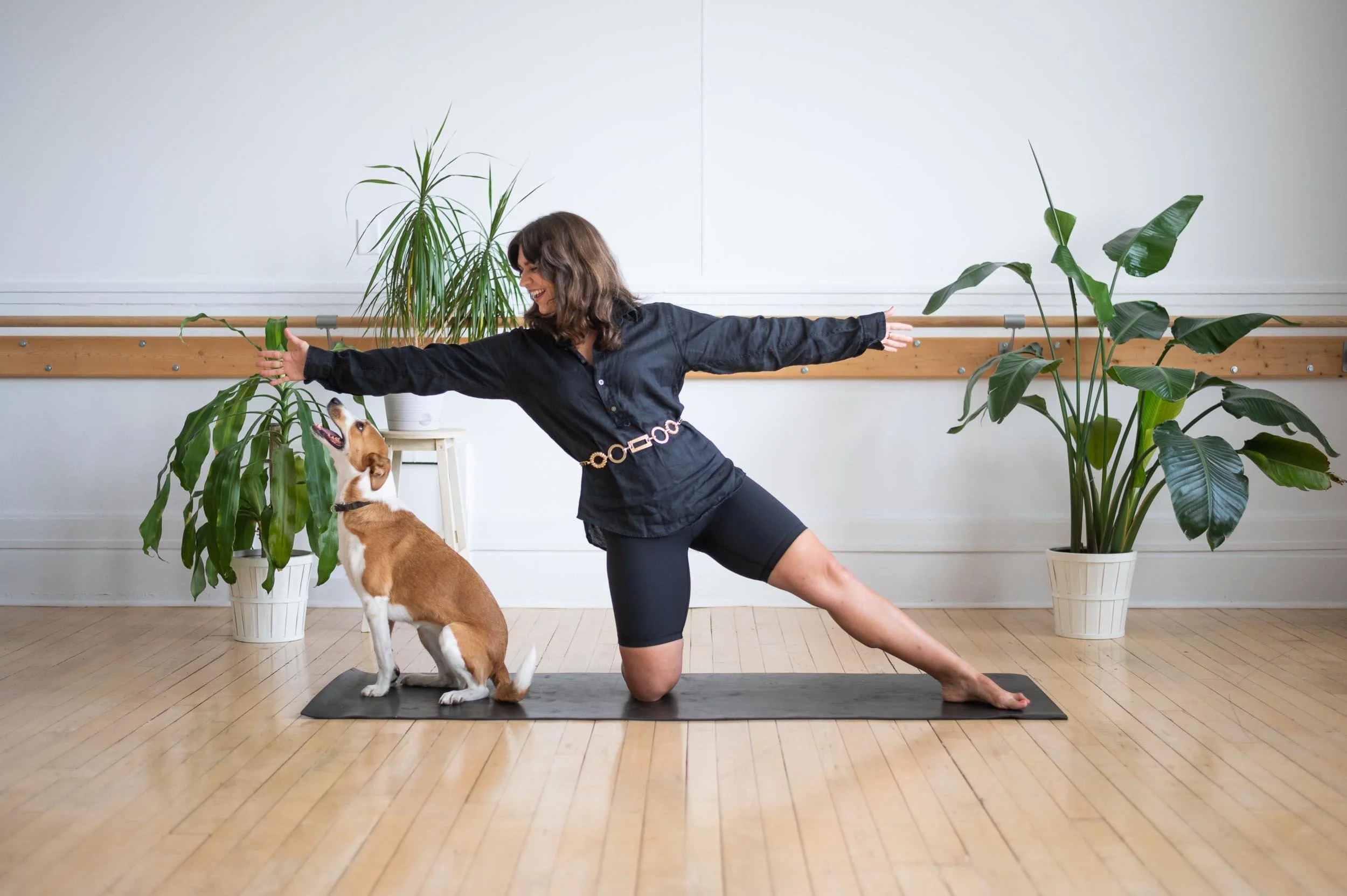 A woman teaches Online pilates with her dog