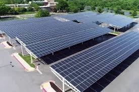 A large parking lot covered with numerous solar panels installed on the roofs of parking structures.