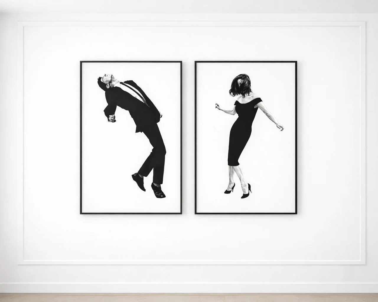Two black and white framed photographs of people dancing, displayed on a white gallery wall.