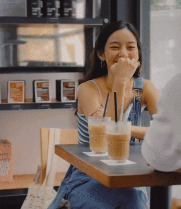 A Kopi Date member sharing an easy, unguarded moment over coffee