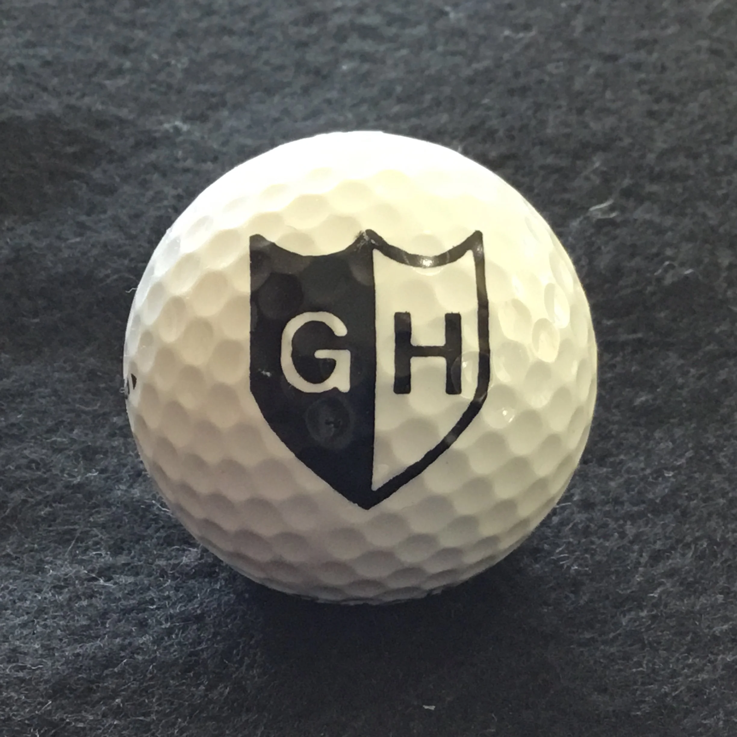 GH in black and white shield