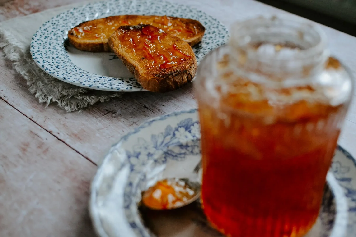 Large jar of orange marmalade on a rustic table with vintage china plates - Josephine Brooks3.jpg
