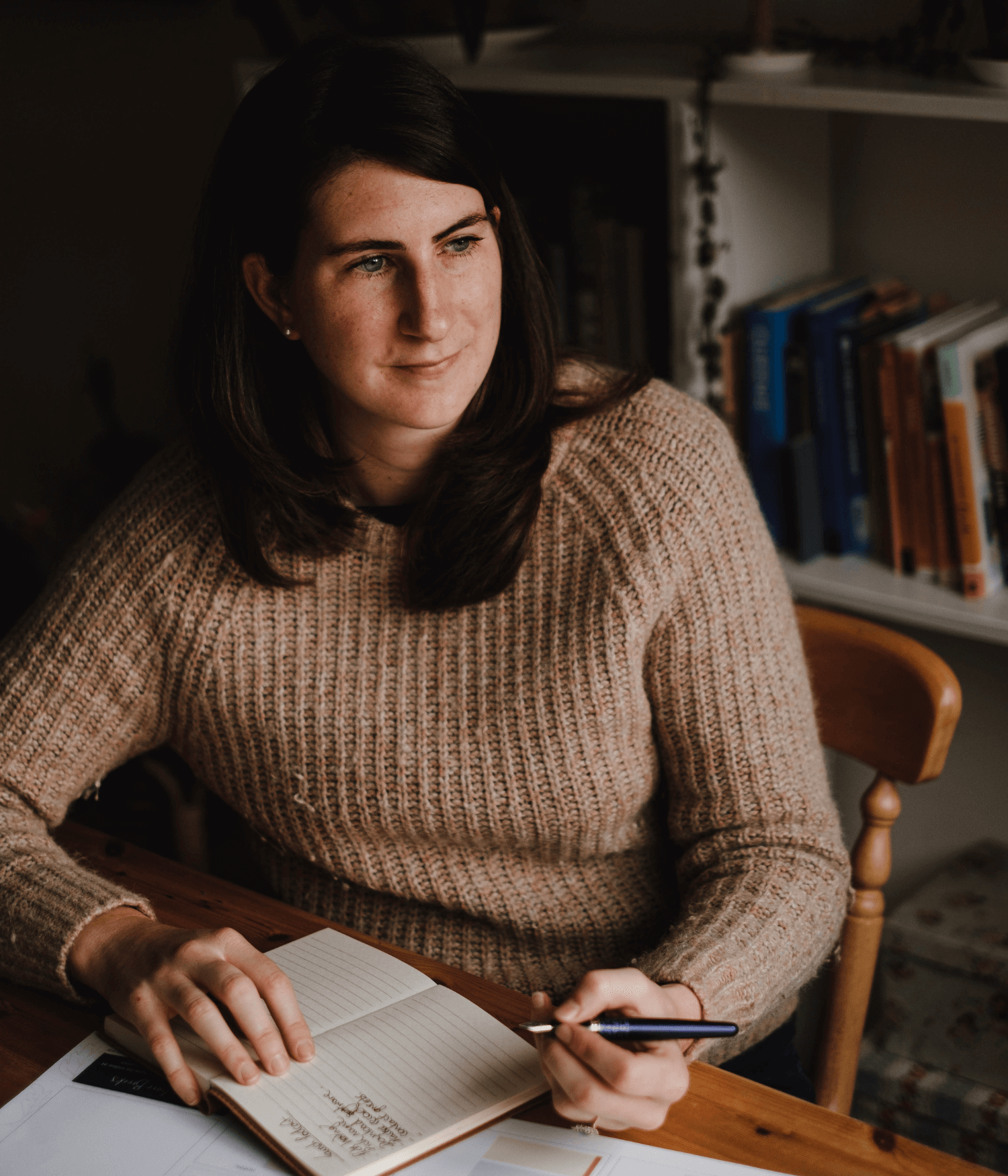 Josephine Brooks sat at a table, planning.png