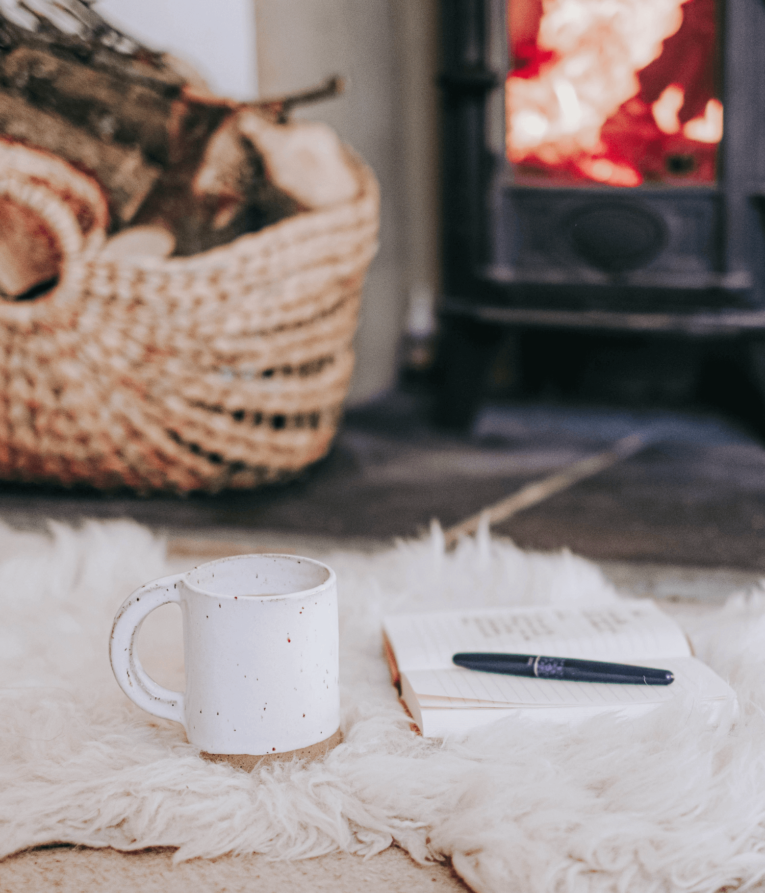 A cosy fire with notebook and pen - Josephine Brooks.png