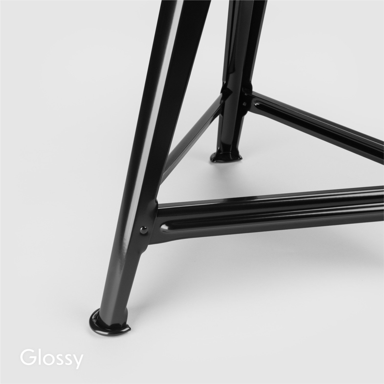 Rowac Model 1 industrial Schemel or workshop stool – detail view of riveted metal / steel foot design. Frame in glossy black.