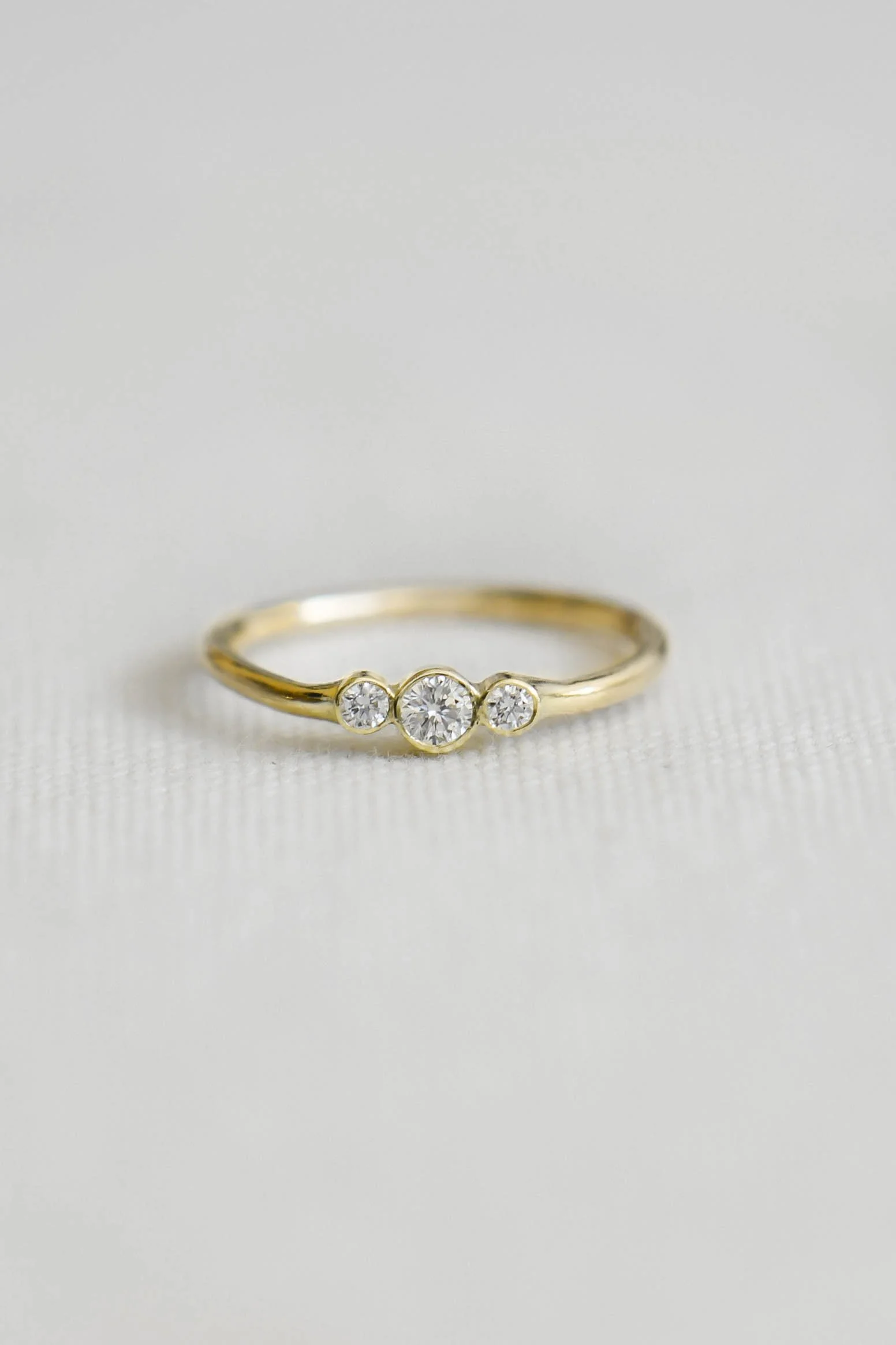 A delicate band in solid 14k gold, set with three white diamonds- gives a soft line of light across the finger. Simple, yet deeply considered. 

Ines is understated and timeless. A ring that doesn’t ask for attention, but holds it gently.