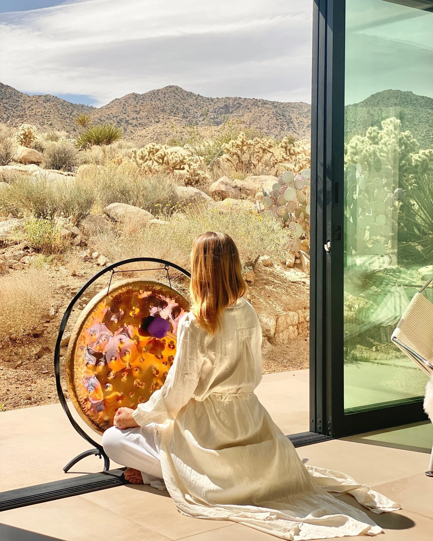 June was a lot.
Full moon. 
Mercury pre-retrograde. 
Flights cancelled one after the other.

Every time I thought I had it sorted, something else fell apart.

This photo is from Joshua Tree. June 2023.
Playing the gong at sunrise, completely off grid