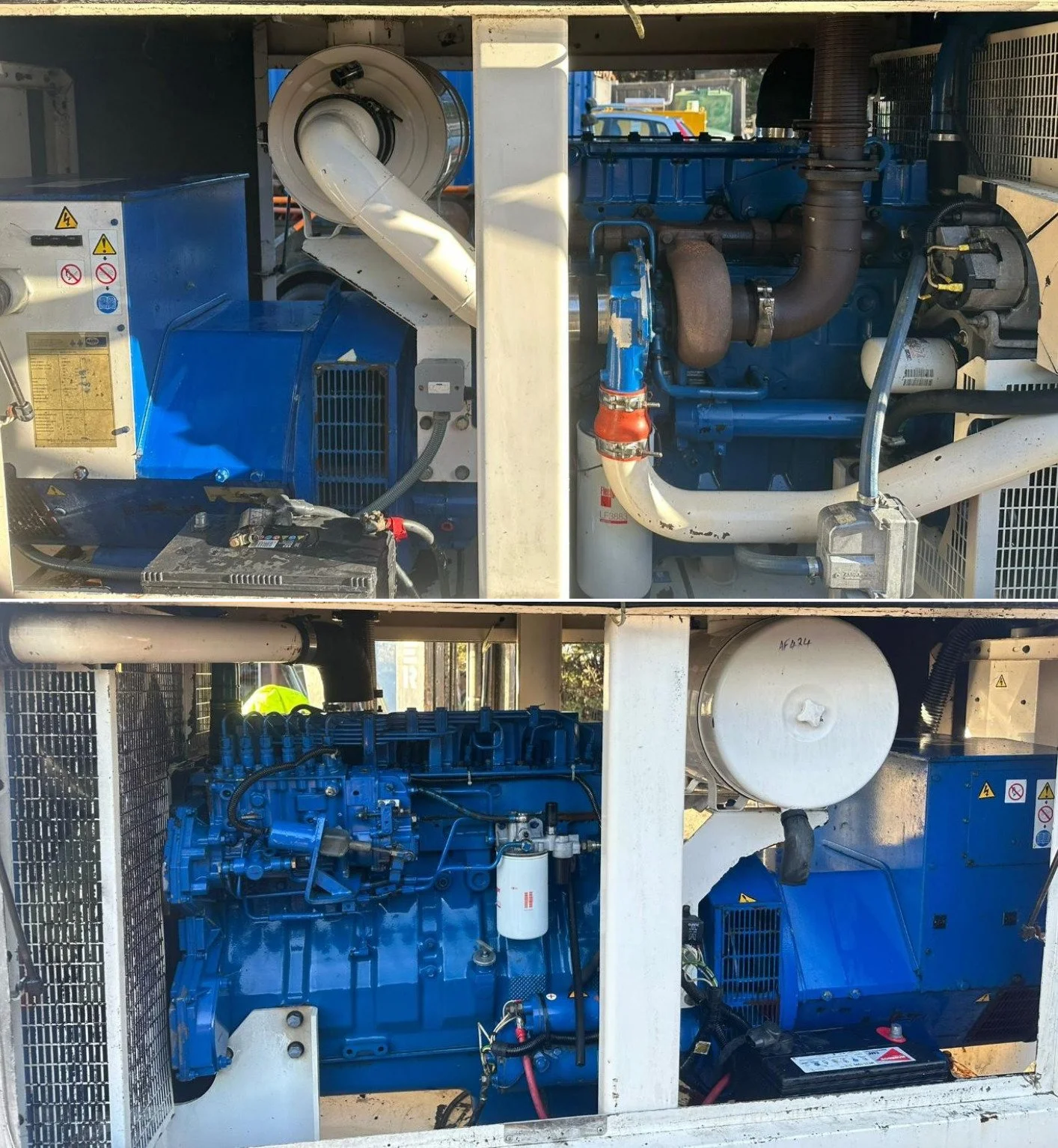A large industrial generator with blue and white components, including a diesel engine, radiator, and various pipes, located outdoors.