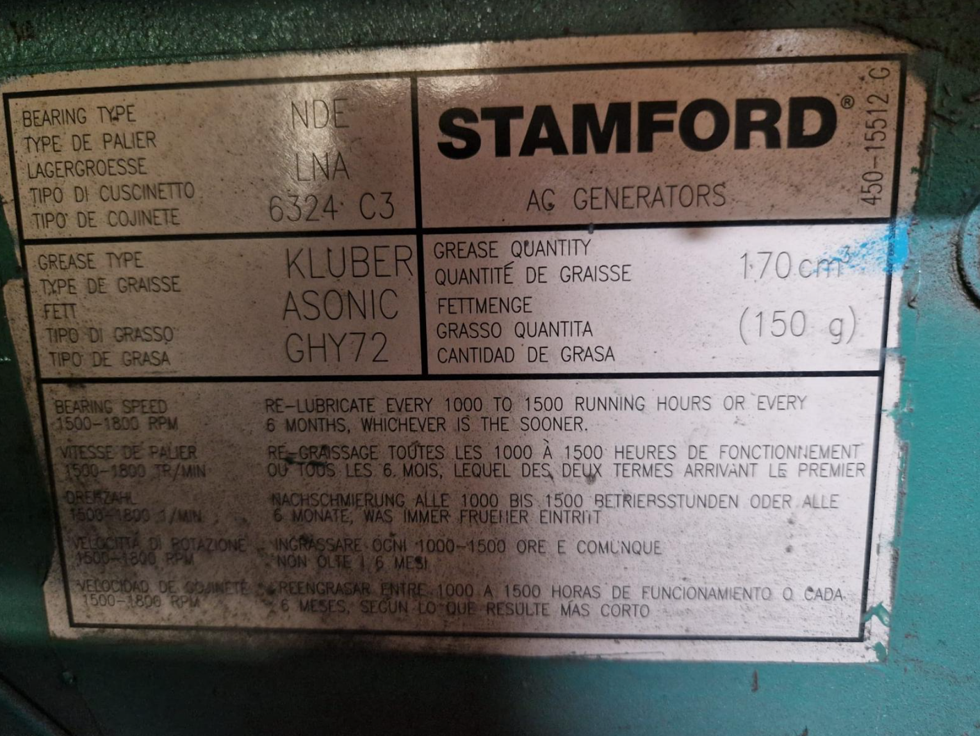 A nameplate on an industrial machine showing specifications for an AG generator. Includes details about bearing type, grease type, grease quantity, and maintenance instructions in multiple languages.