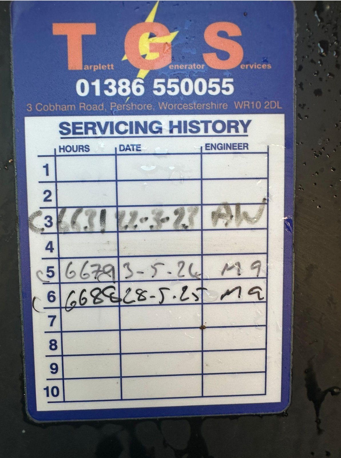 Service history sticker from a company named T G S at 3 Cobham Road, Pershore, Worcester, showing two handwritten service records, including dates and technician initials.