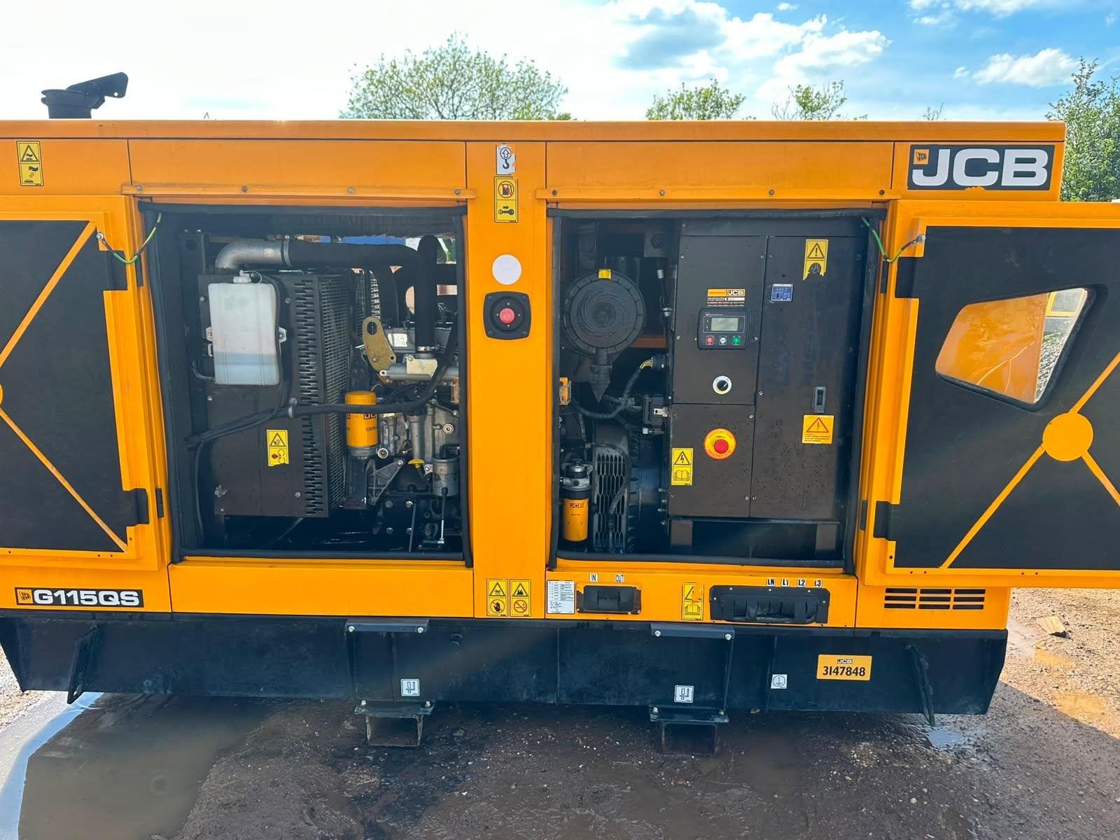 Open side panels of a yellow JCB G115QSC generator showing internal engine parts and controls.