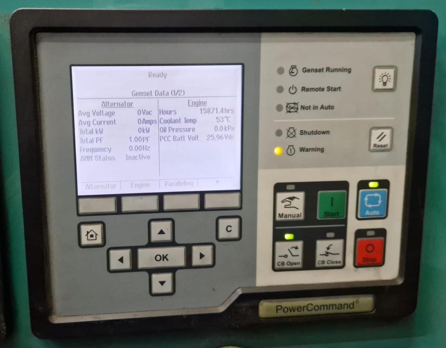 Control panel displaying engine and alternator data including voltage, current, kilowatt hours, coolant temperature, and oil pressure, with various buttons and indicator lights.