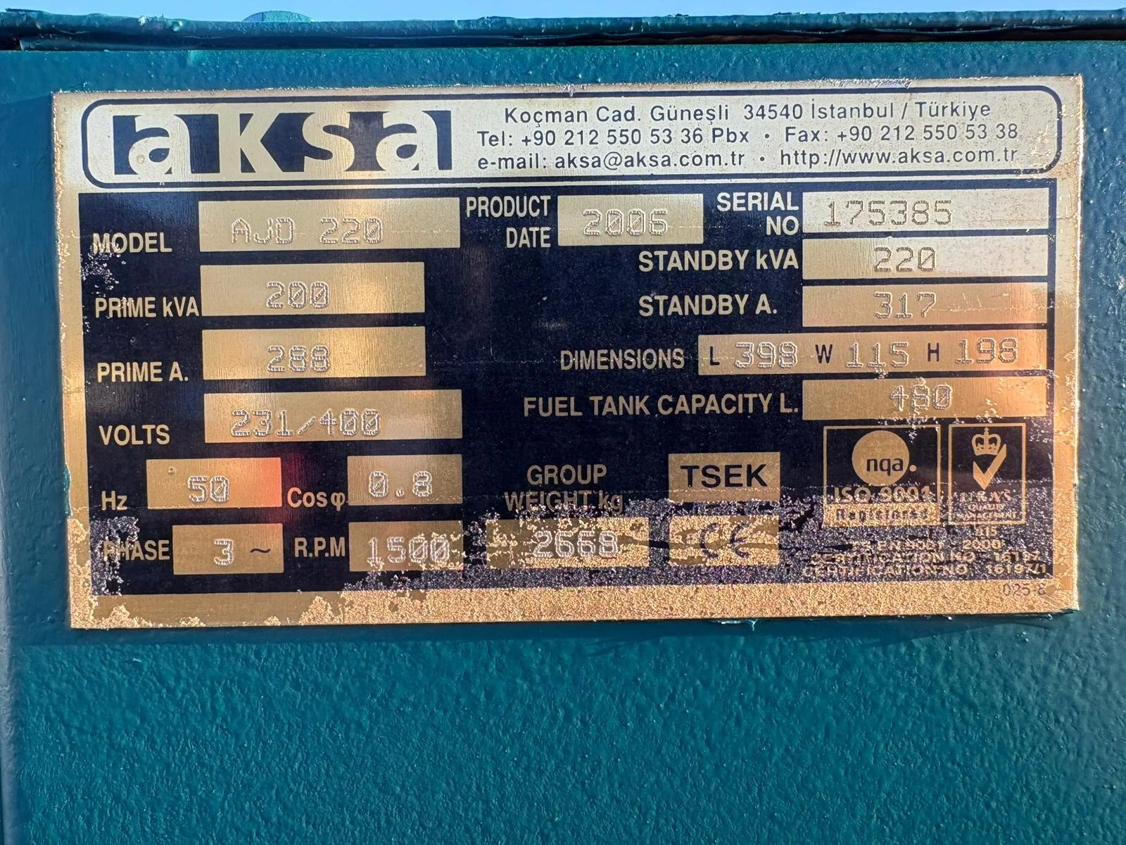 Metal identification plate on machinery with specifications such as model, serial number, manufacturing date, power ratings, dimensions, and certifications.