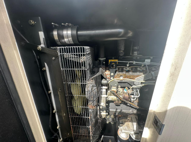 Close-up view of an industrial or commercial engine’s internal components, including a radiator, pipes, and metallic parts.