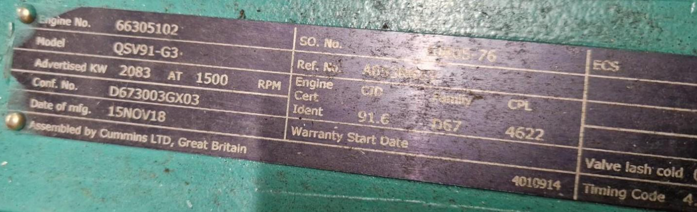 Close-up of a metal equipment identification plate with technical specifications and manufacturing details.