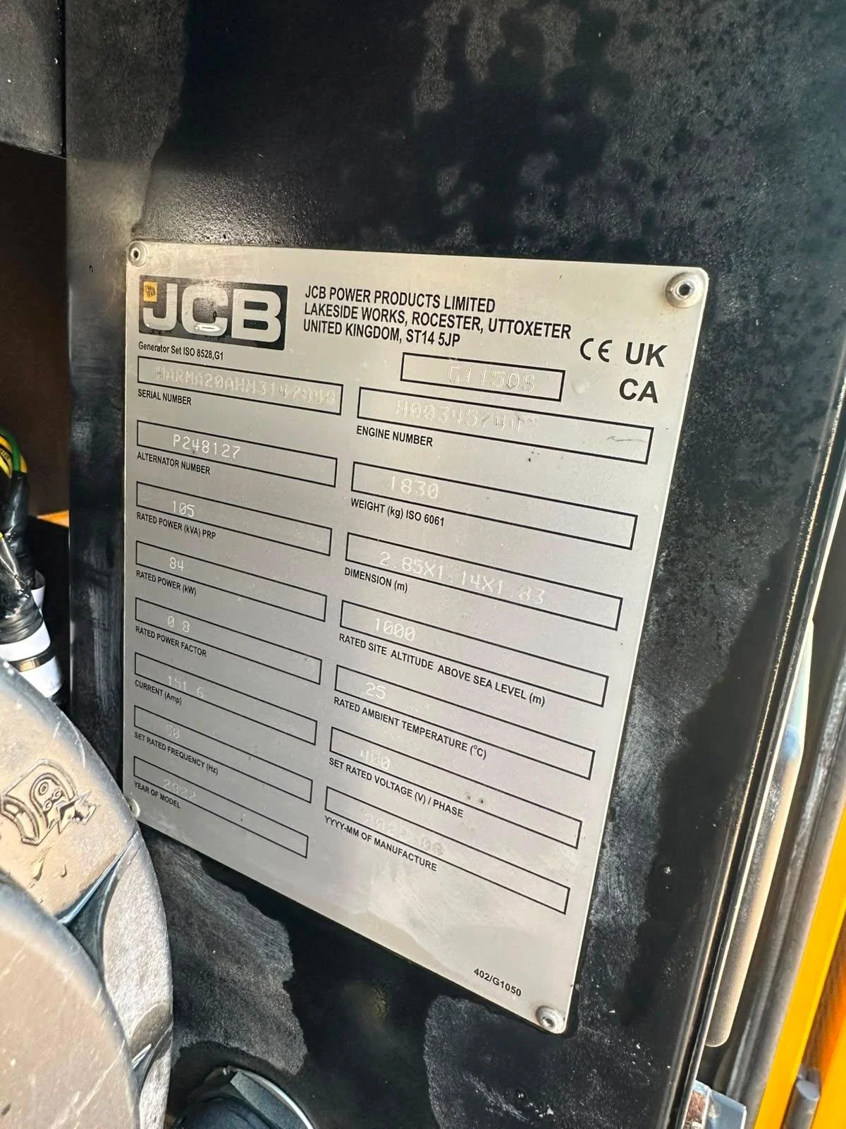 Metal identification plate on a generator with details including the manufacturer, serial number, engine number, weight, dimensions, and electrical specifications.