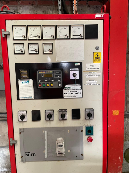 An industrial control panel with multiple meters, switches, and buttons.