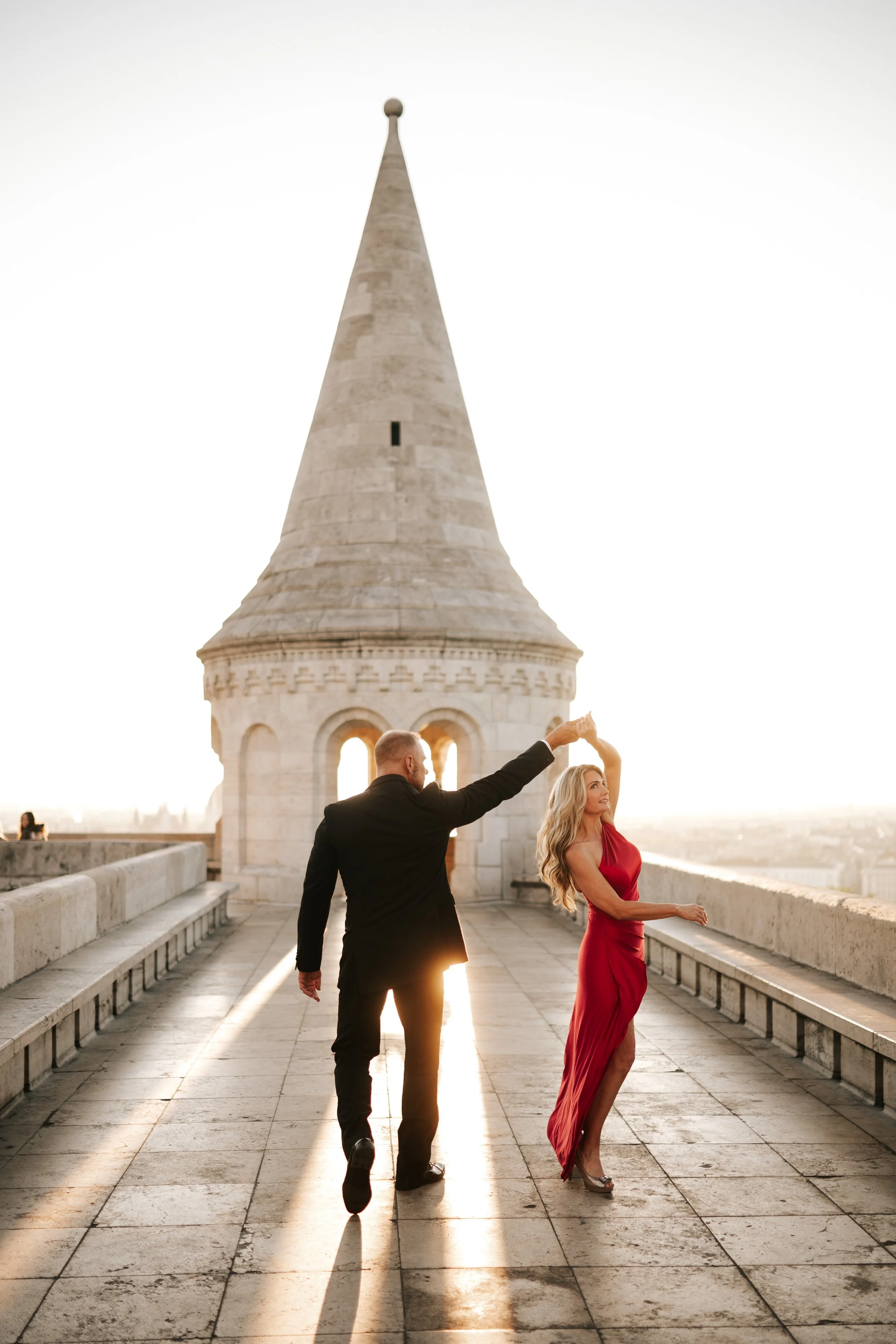 A twirl on the terrace, her red dress catching the morning light at Fisherman’s Bastion
