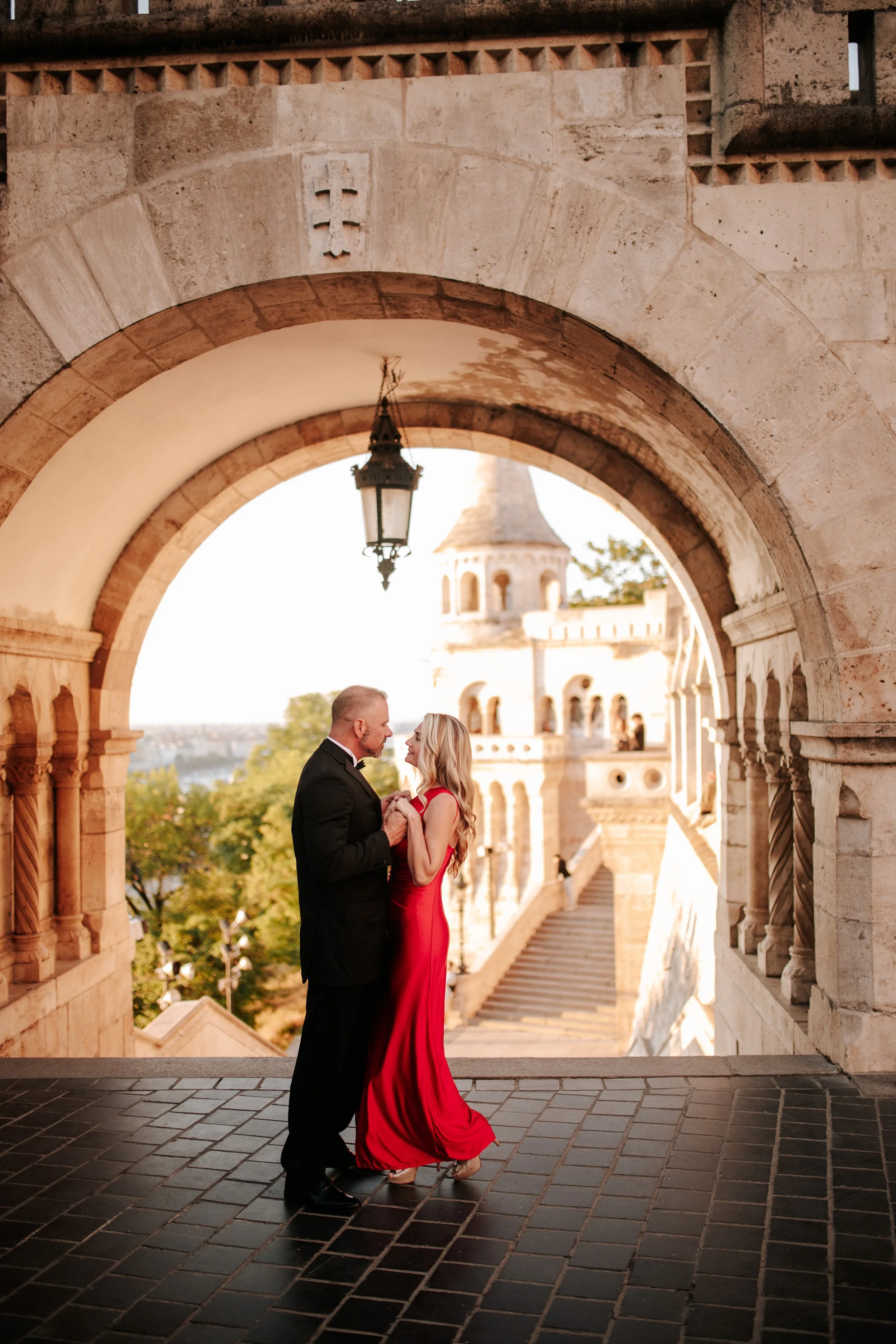 Face to face beneath the stone archway and hanging lantern at Fisherman’s Bastion