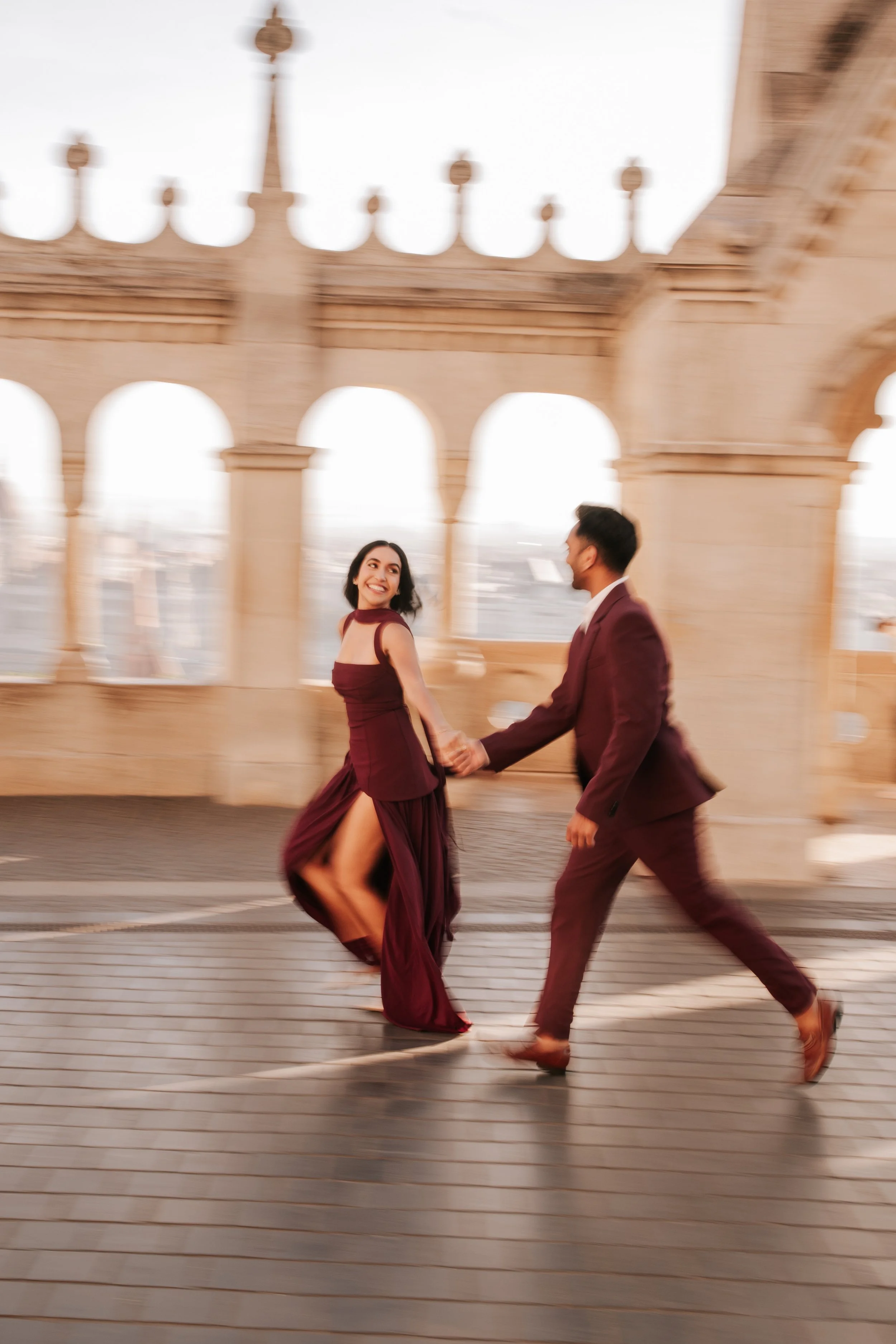 Running hand in hand across the terrace, captured with motion blur