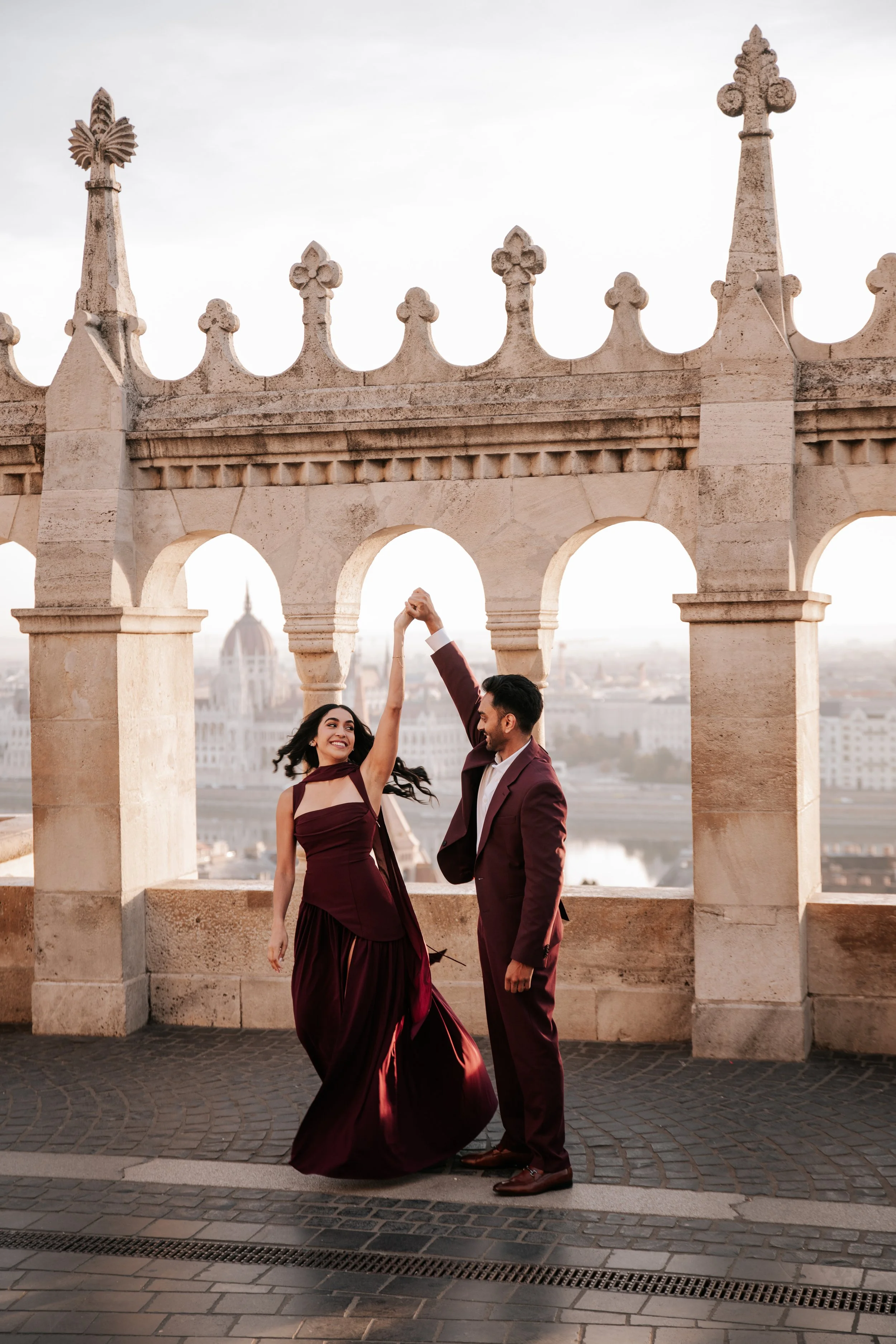 A twirl beneath the arches during their sunrise photoshoot in Budapest
