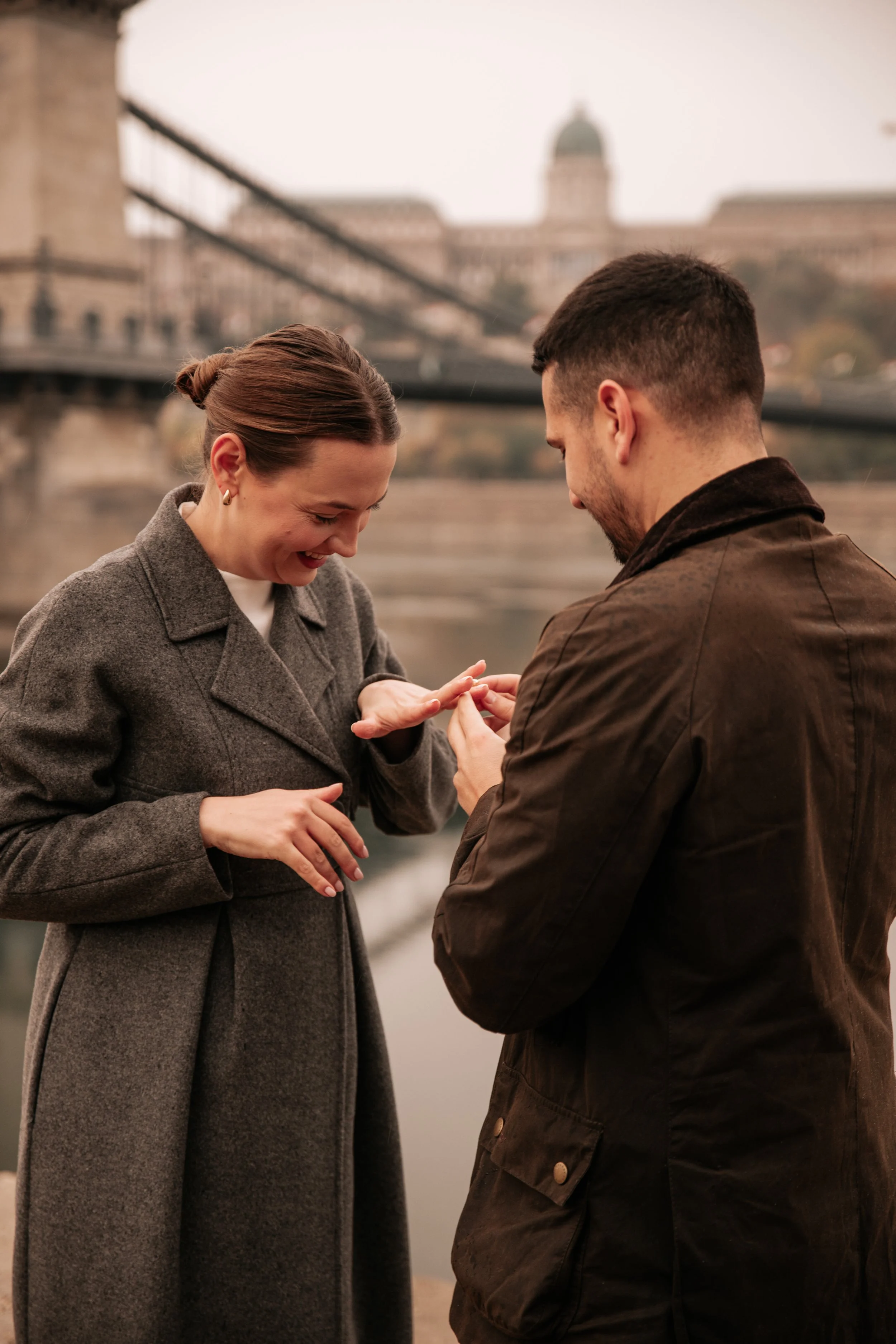 The ring exchange during a riverside proposal photoshoot in Budapest