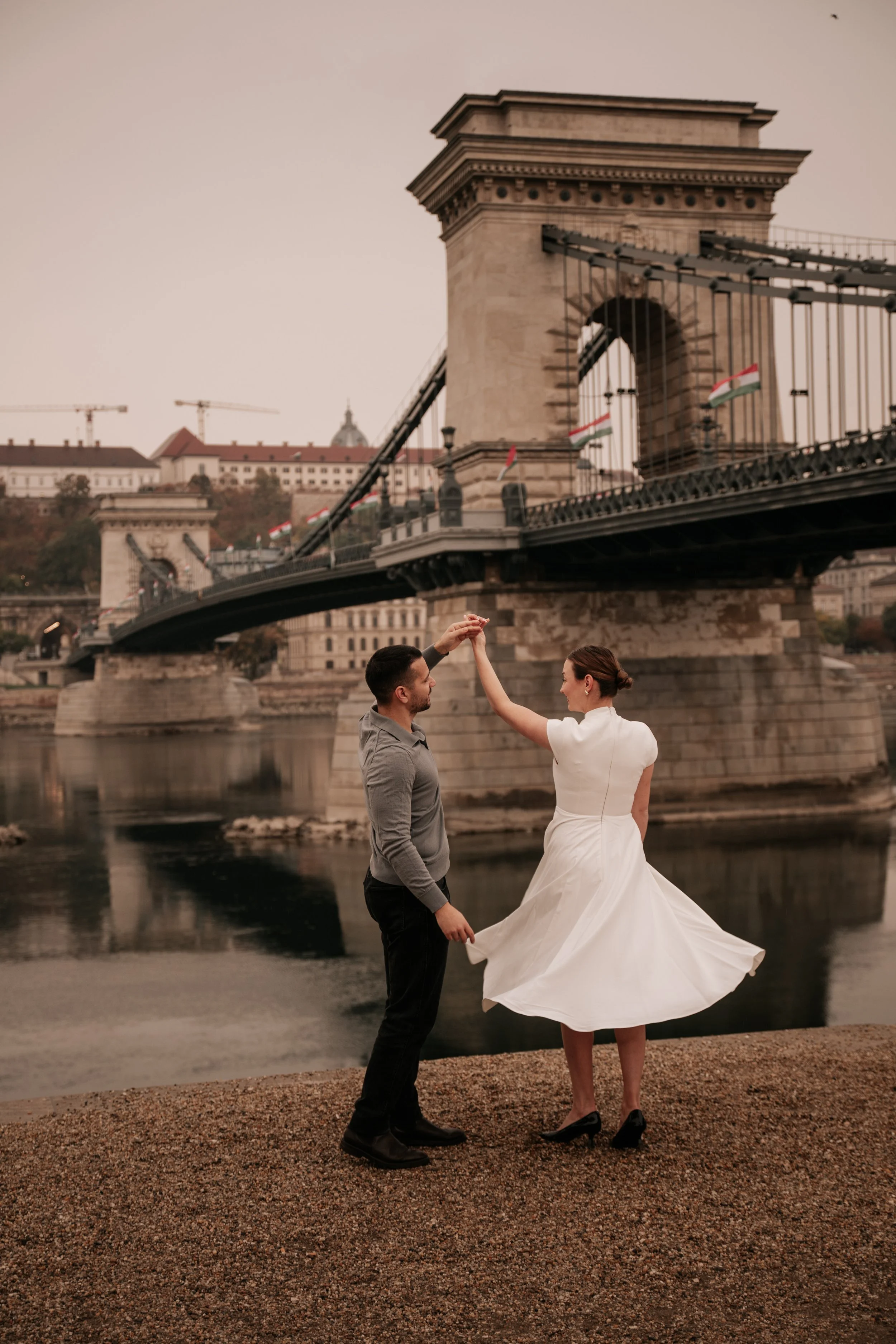 A twirl by the Chain Bridge during their post-proposal photoshoot