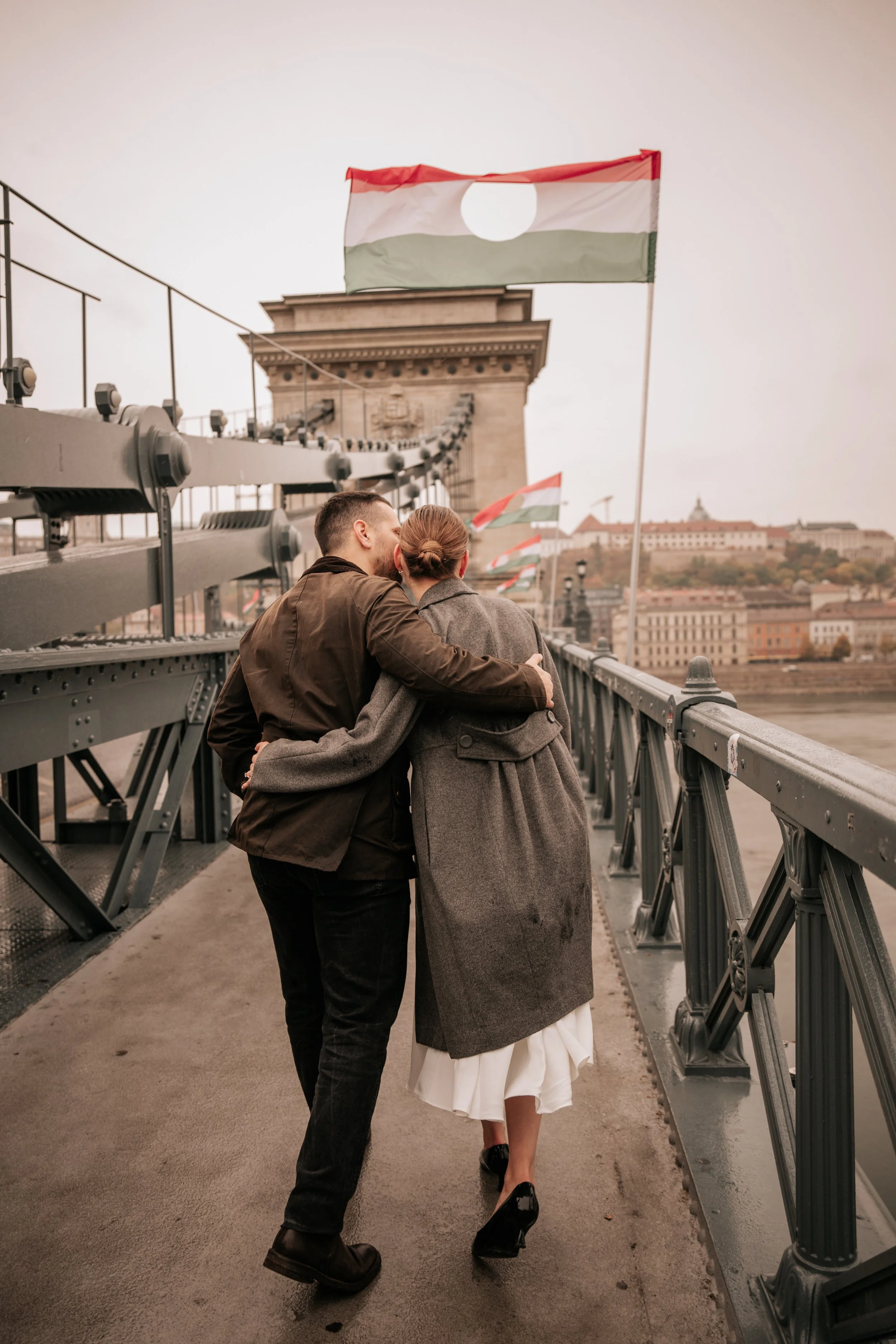 Finishing their proposal photoshoot with a walk across Budapest’s Chain Bridge