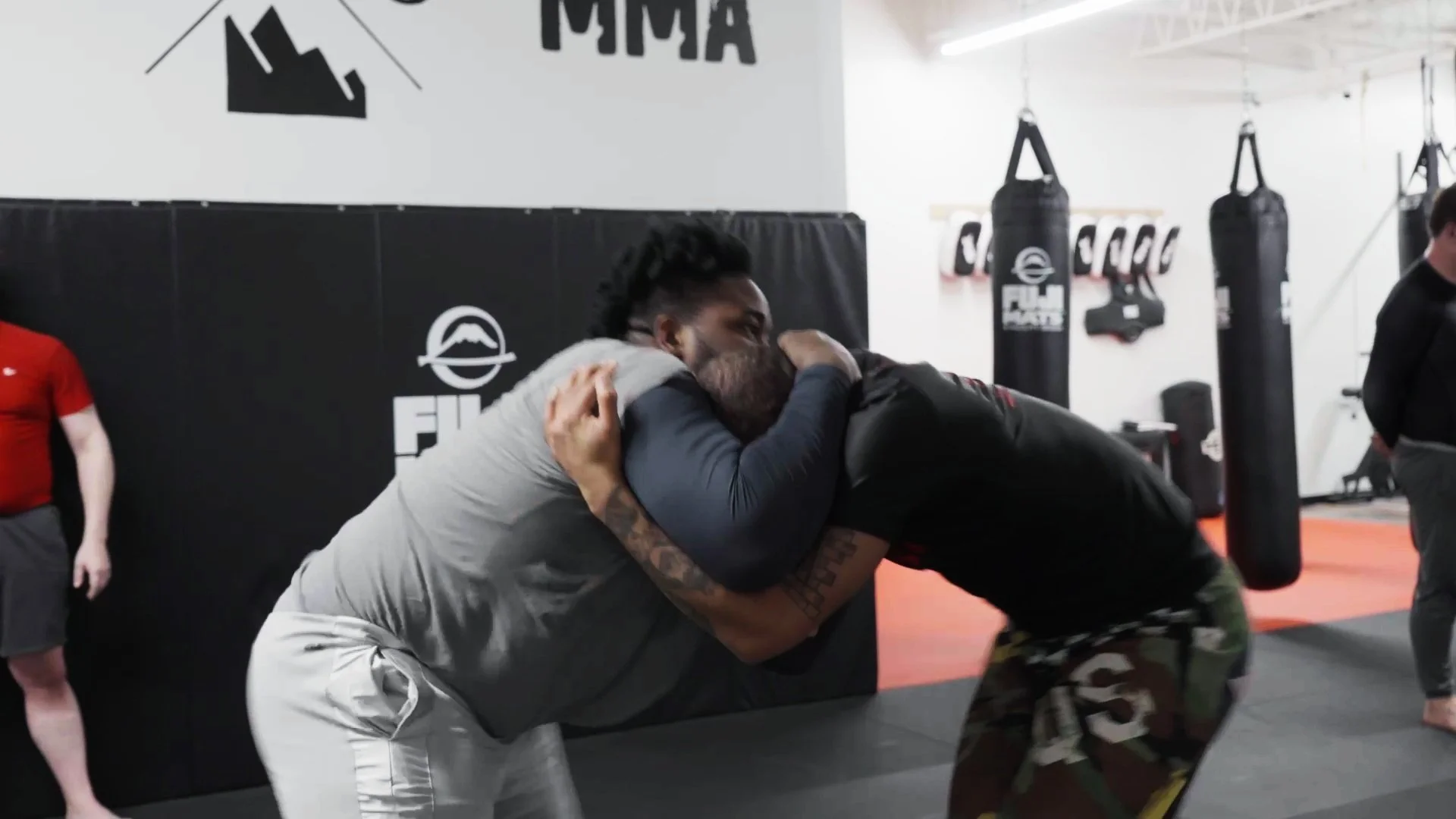 Two students practicing headlock control during a wrestling class at Elements MMA in Keene, NH