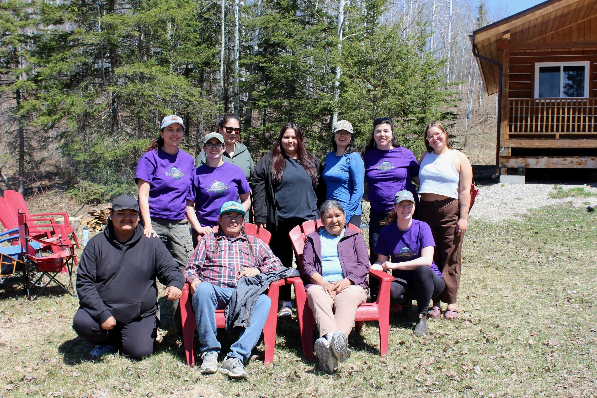 A photo of Elders, staff, and youth smiling for the camera!