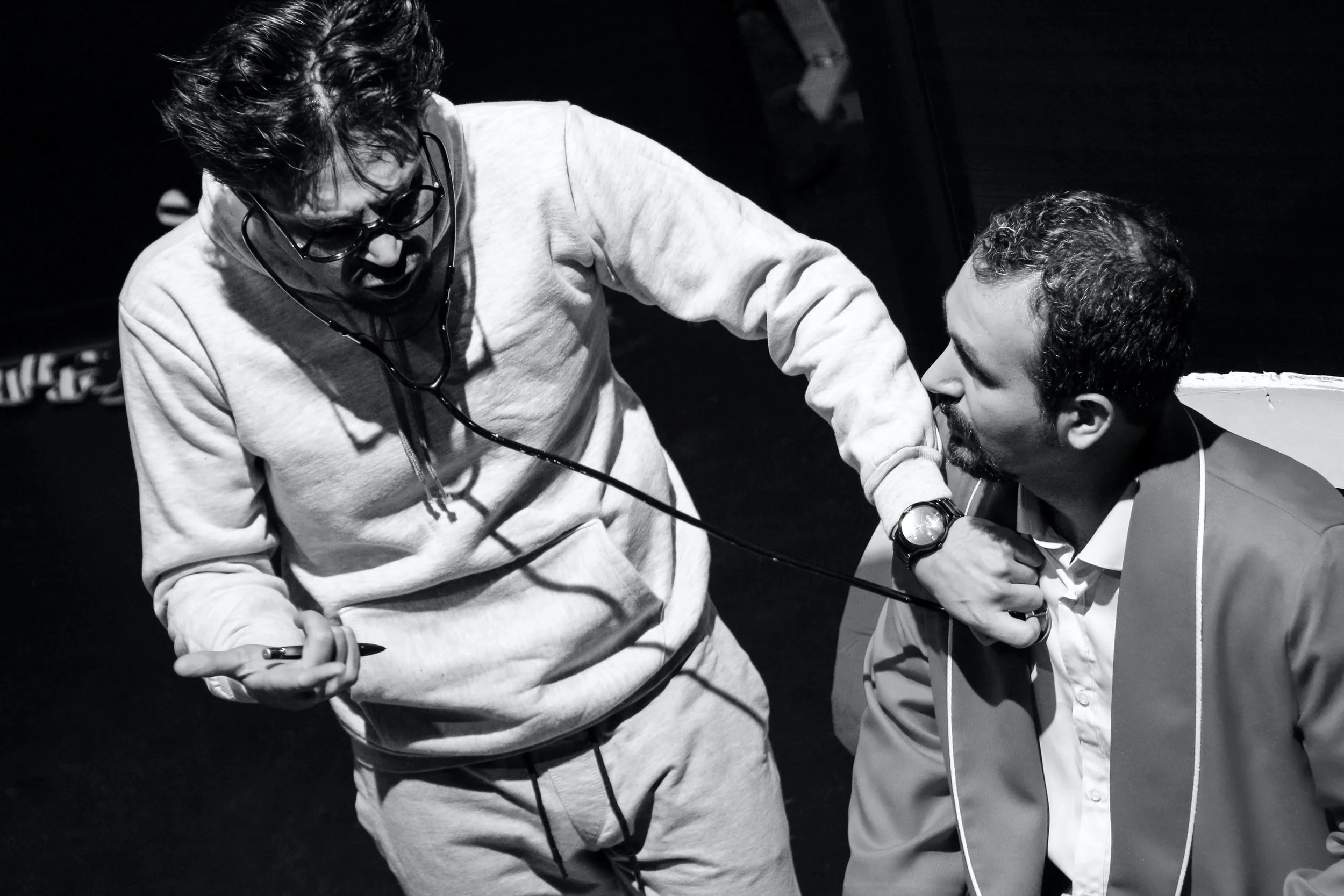 man checking another man's heart signifying check the shame that someone bears