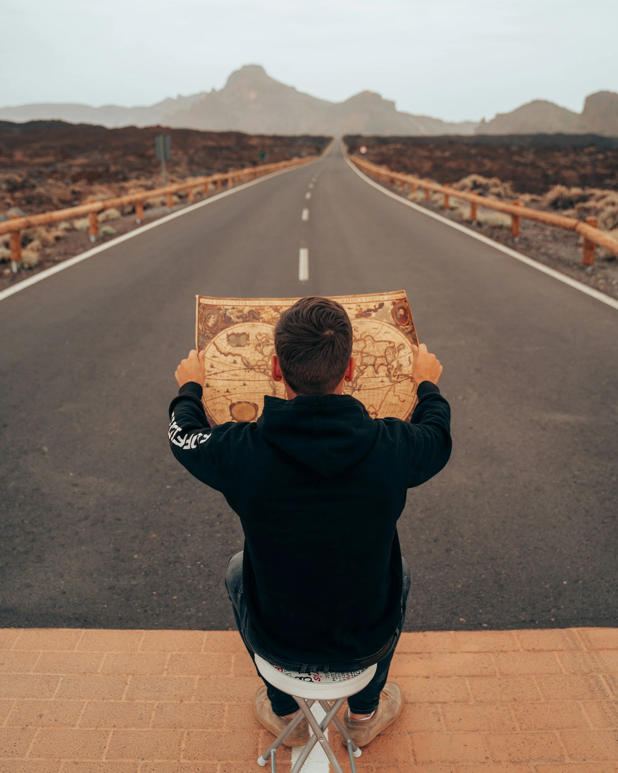 a map studying a map in the desert signifying his search for recovery