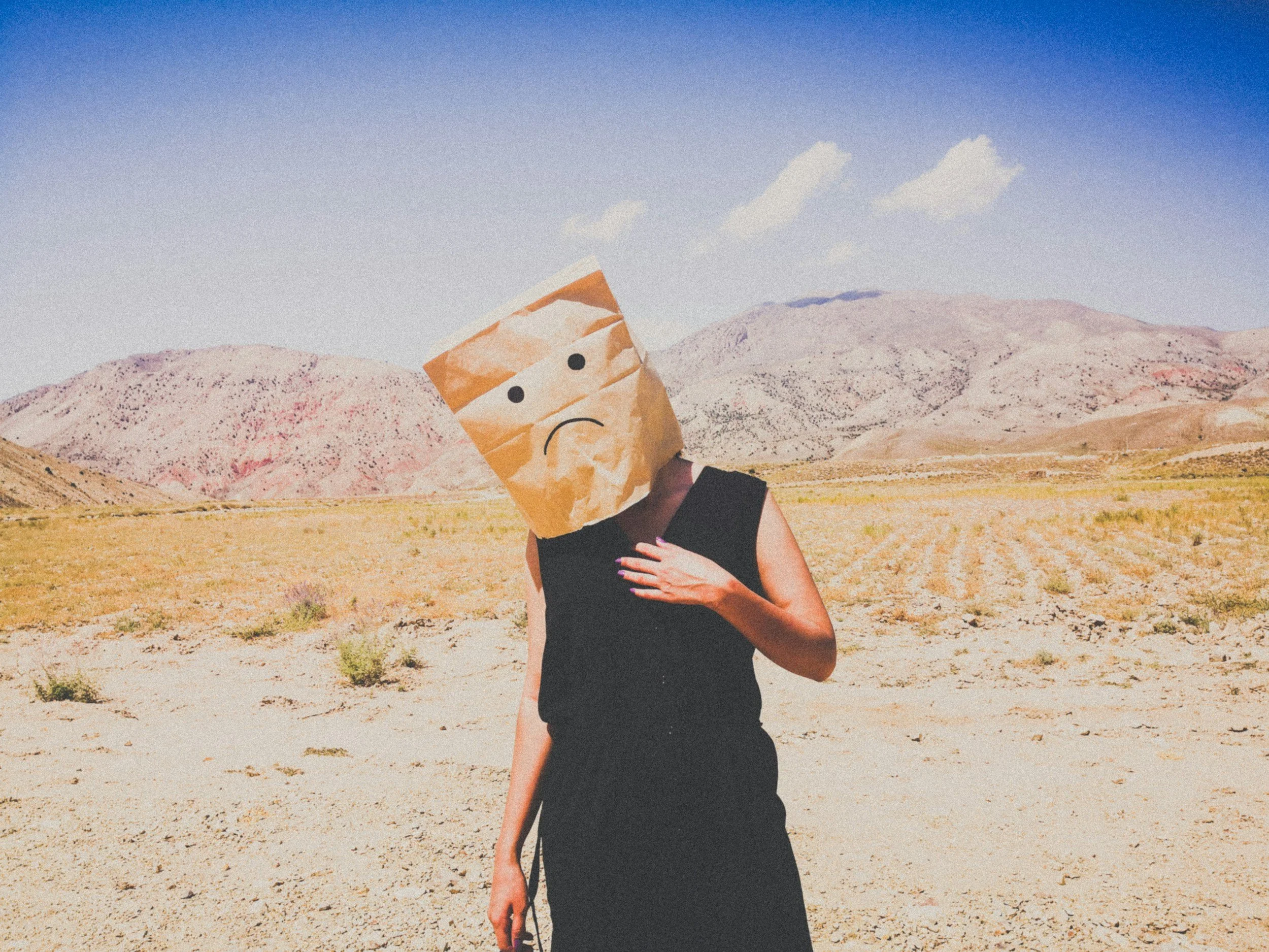 a man with a bag over his face with a frown