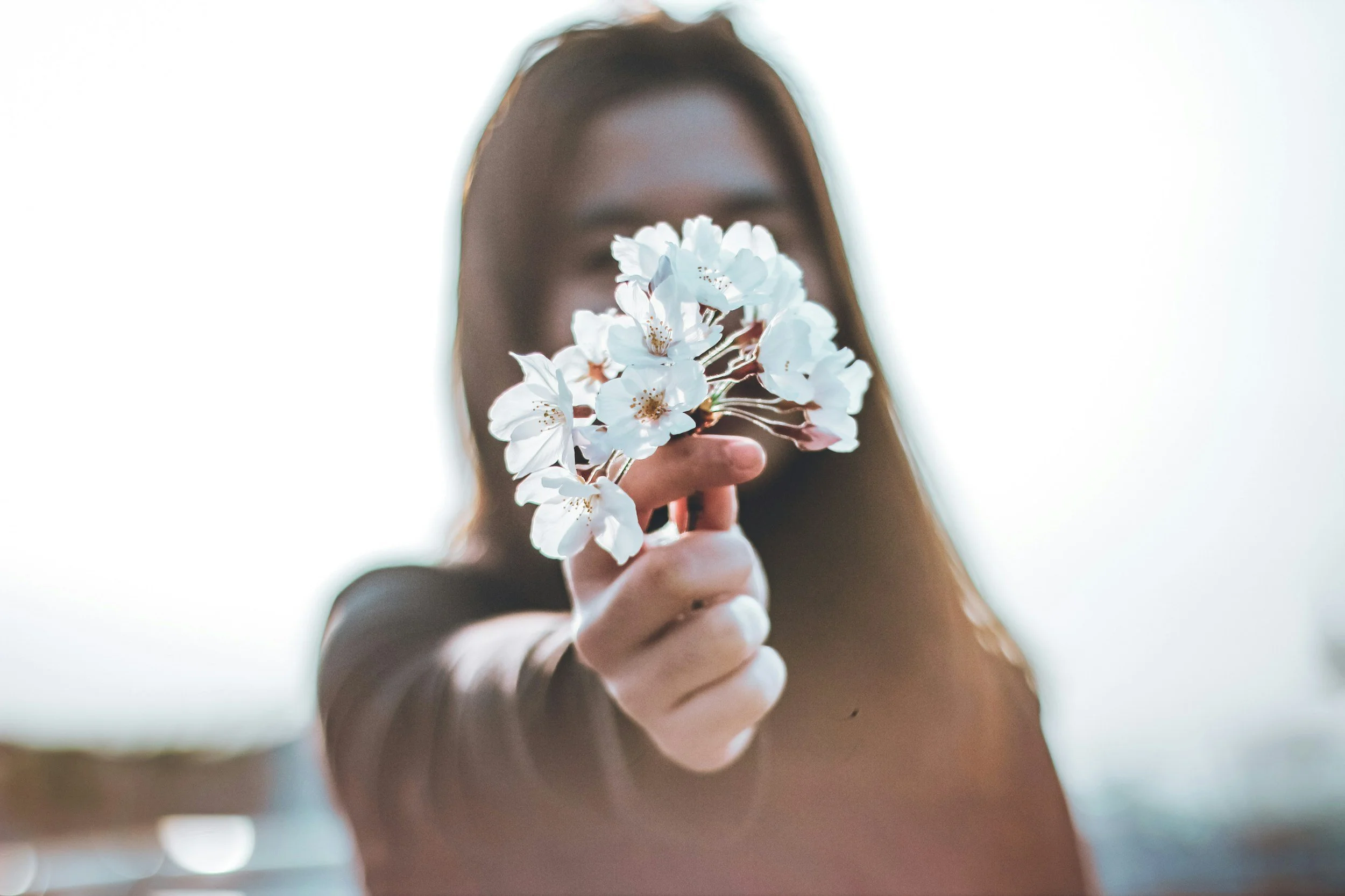 a woman with a flower showing that she's a peace with herself