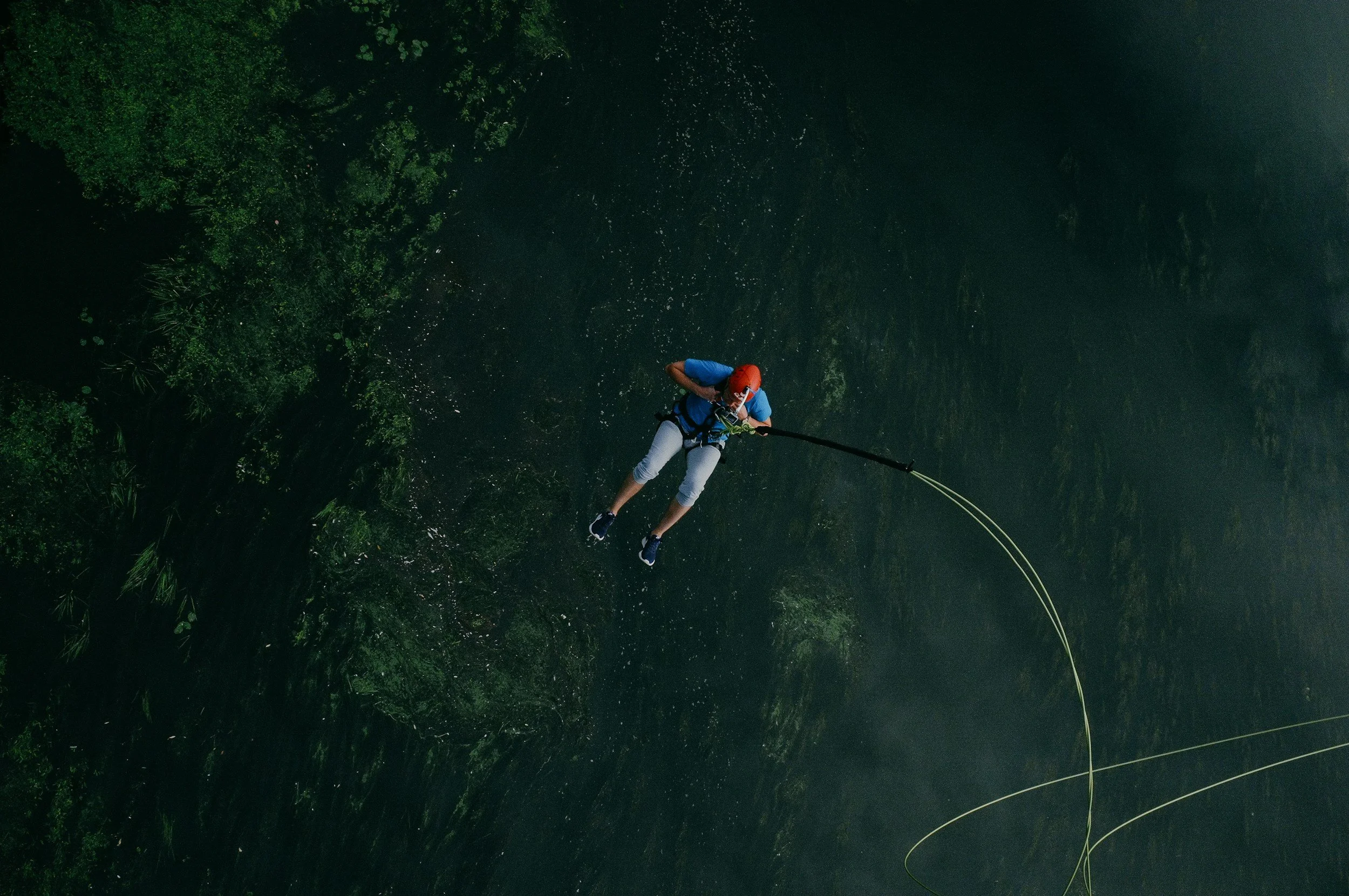 a man suspended on a rope. Should you let him drop?