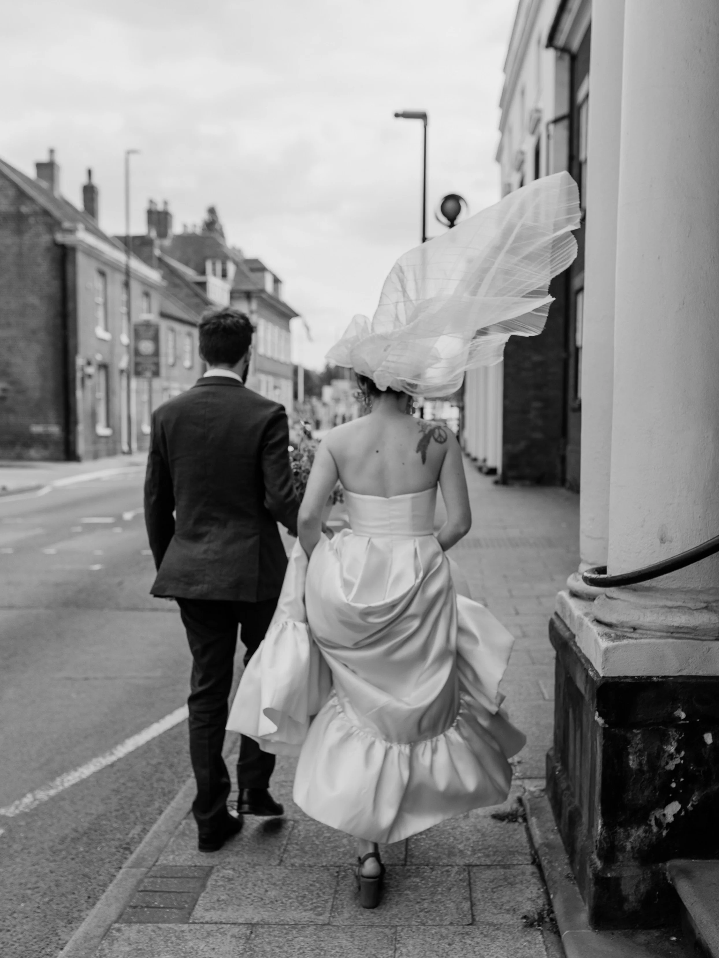 A veil with absolutely no intention of behaving.
I just love wedding photos like this. 

Nothing staged, just walking down the street together, dress hitched up, veil doing whatever it likes and me following along behind.

It&rsquo;s usually these li
