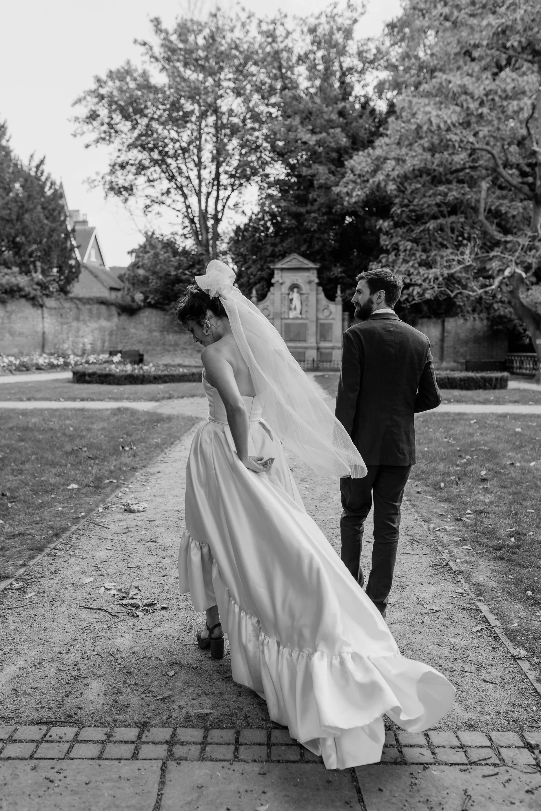 Newlyweds walking together through the gardens on their wedding day in Litchfield.