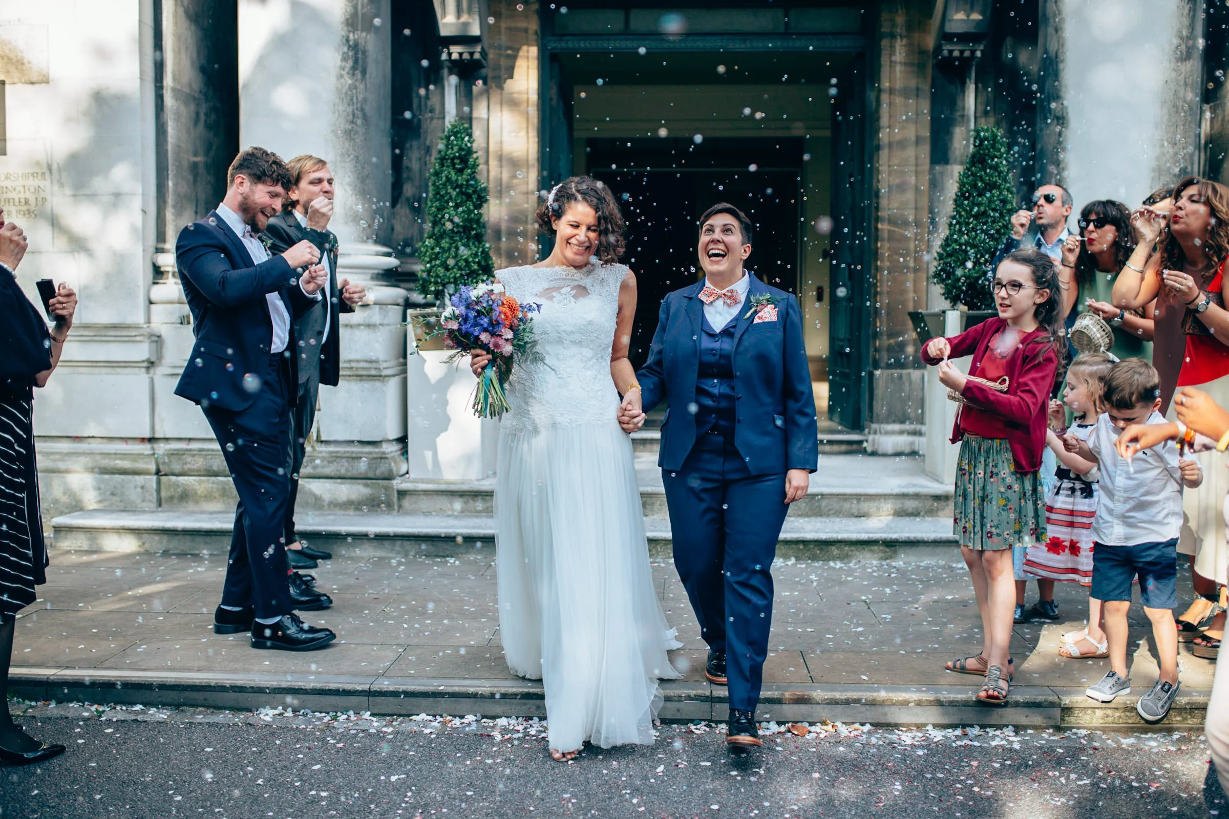 LGBTQ couple enjoying their confetti shot infront of Stoke Newington Town Hall, London.