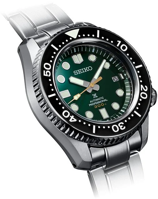 Seiko diver's watch with a green dial, black bezel, and silver metal strap.