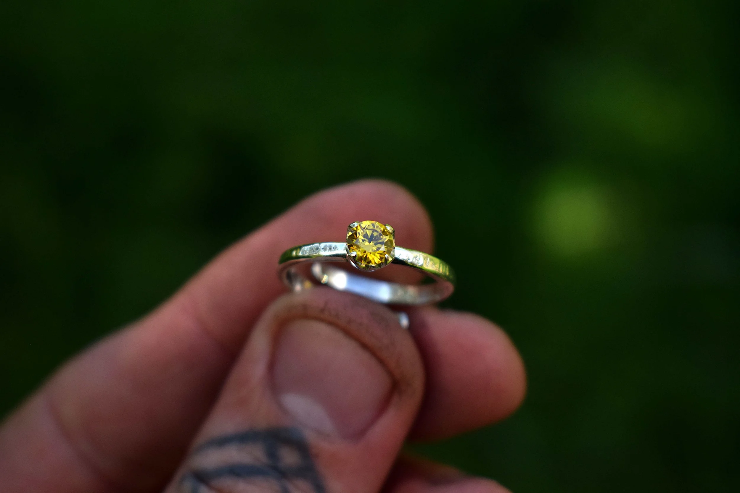 Cubic zirconia, gold, set in a sterling silver ring. Handmade