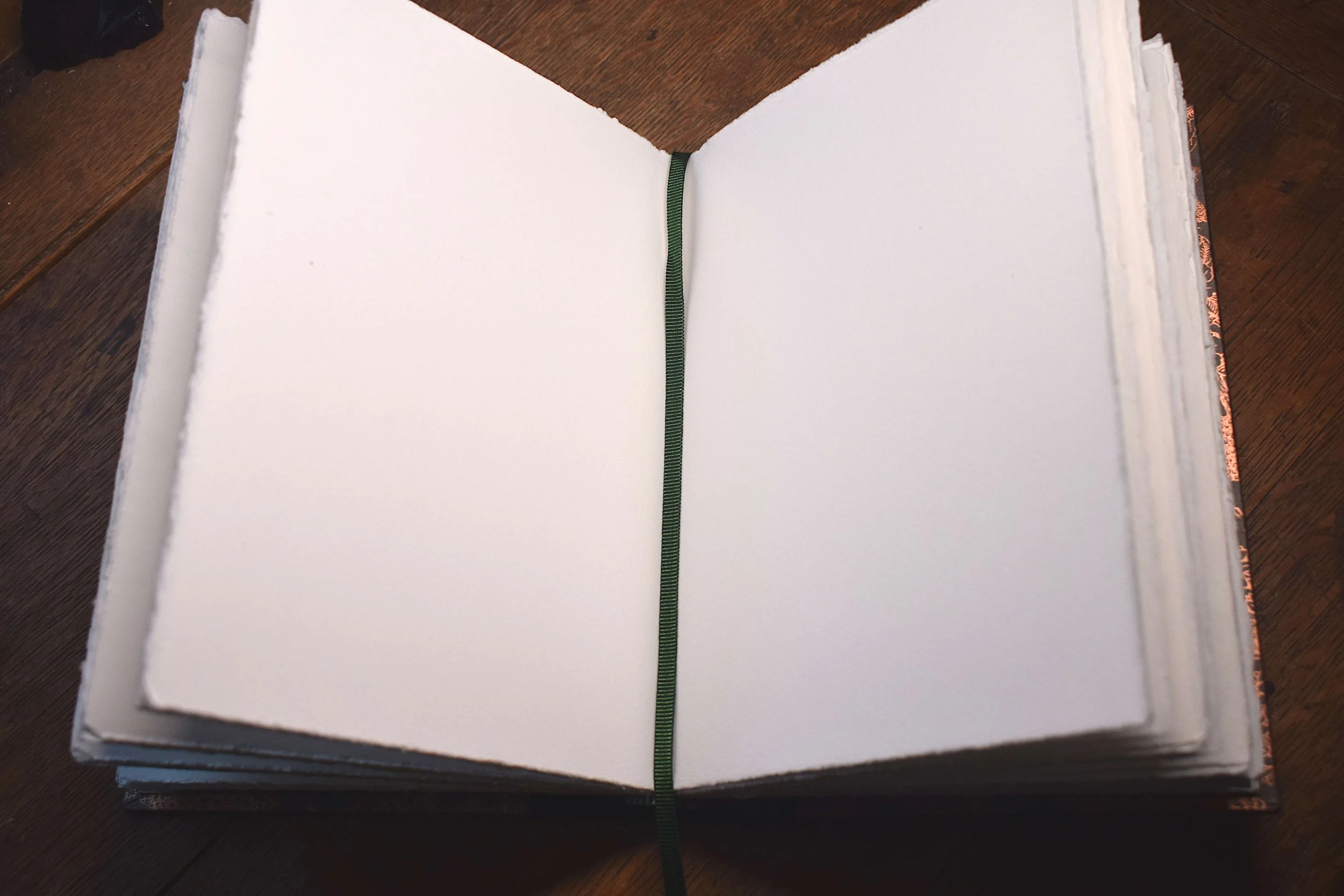 Hand made sketchbook, with white watercolour paper and green ribbon