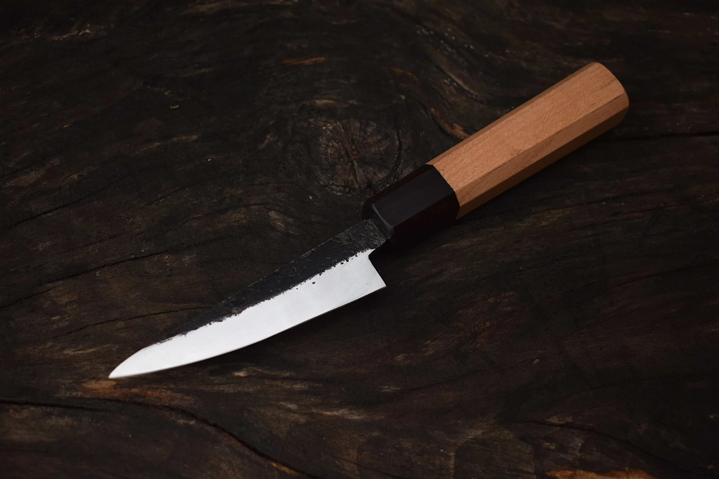 Close up of hand made kitchen knife from steel and wood
