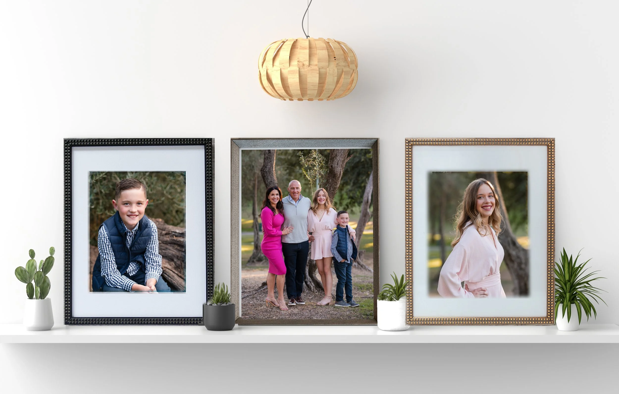 3 photo frames of a family on a decorative shelf
