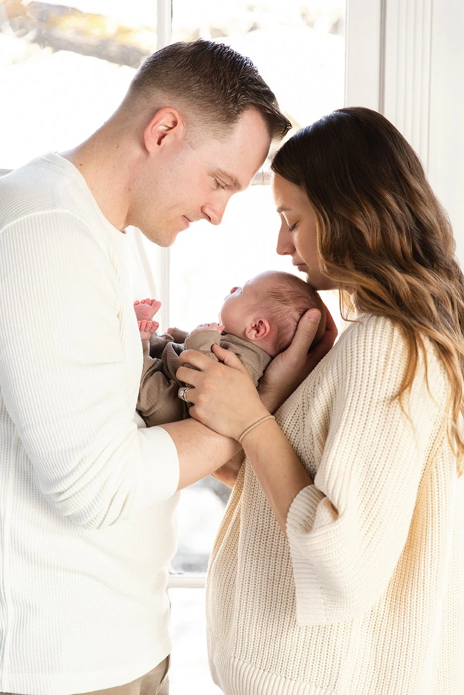 studio newborn window profile of parents.jpg